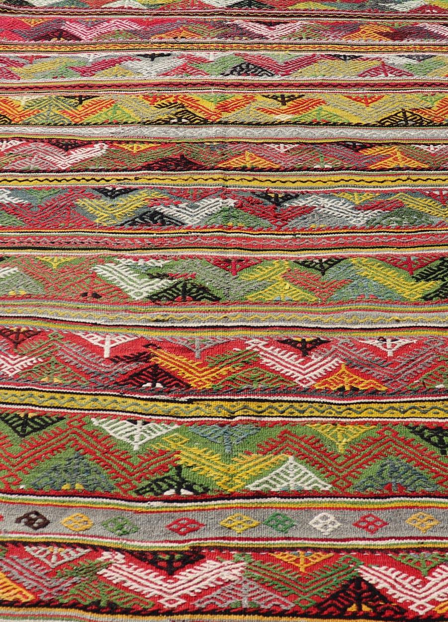 Bright colorful vintage Turkish hand woven embroidered kilim with all-over tribal motif design. Keivan Woven Arts / rug TU-NED-5040, country of origin / type: Turkey / Kilim, circa 1960

Measures: 5'5 x 7'8 

This vintage Turkish flat-woven Kilim