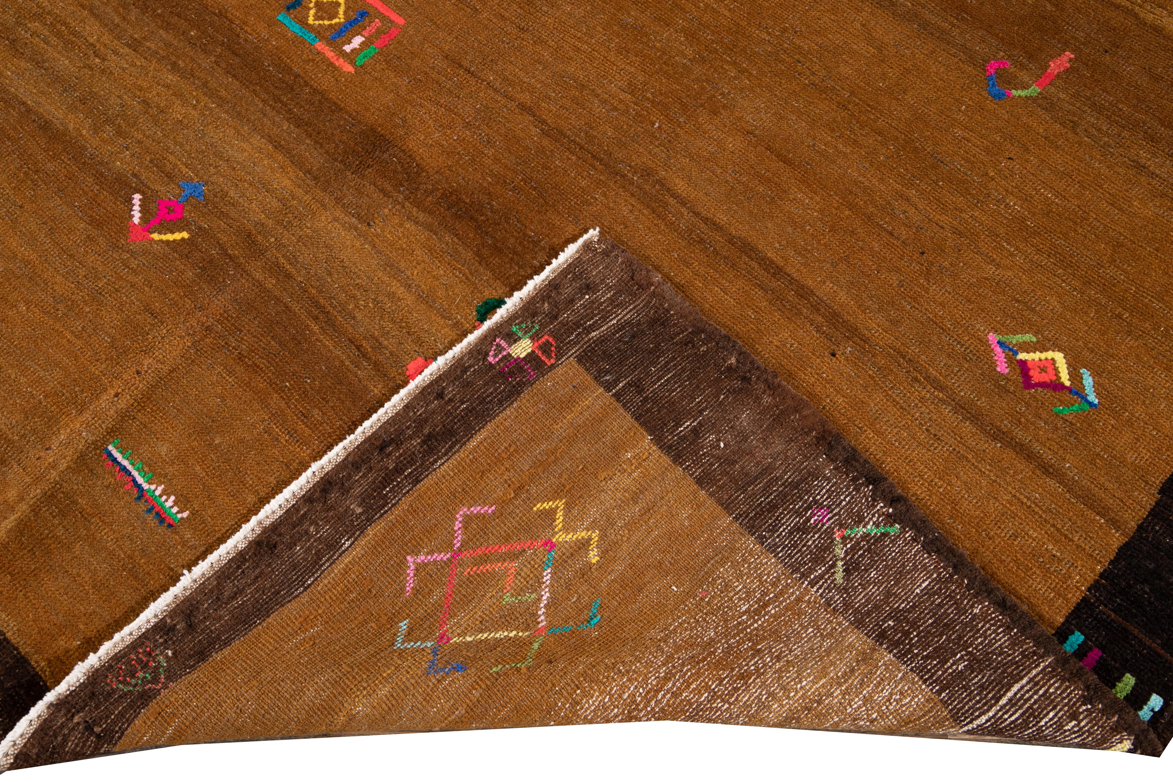 Schöner türkischer handgeknüpfter Wollteppich mit hellbraunem Feld. Dieser türkische Teppich mit braunem Rahmen und mehrfarbigen Akzenten hat ein wunderschönes geometrisches, expressionistisches Design.

Dieser Teppich misst: 6' 1