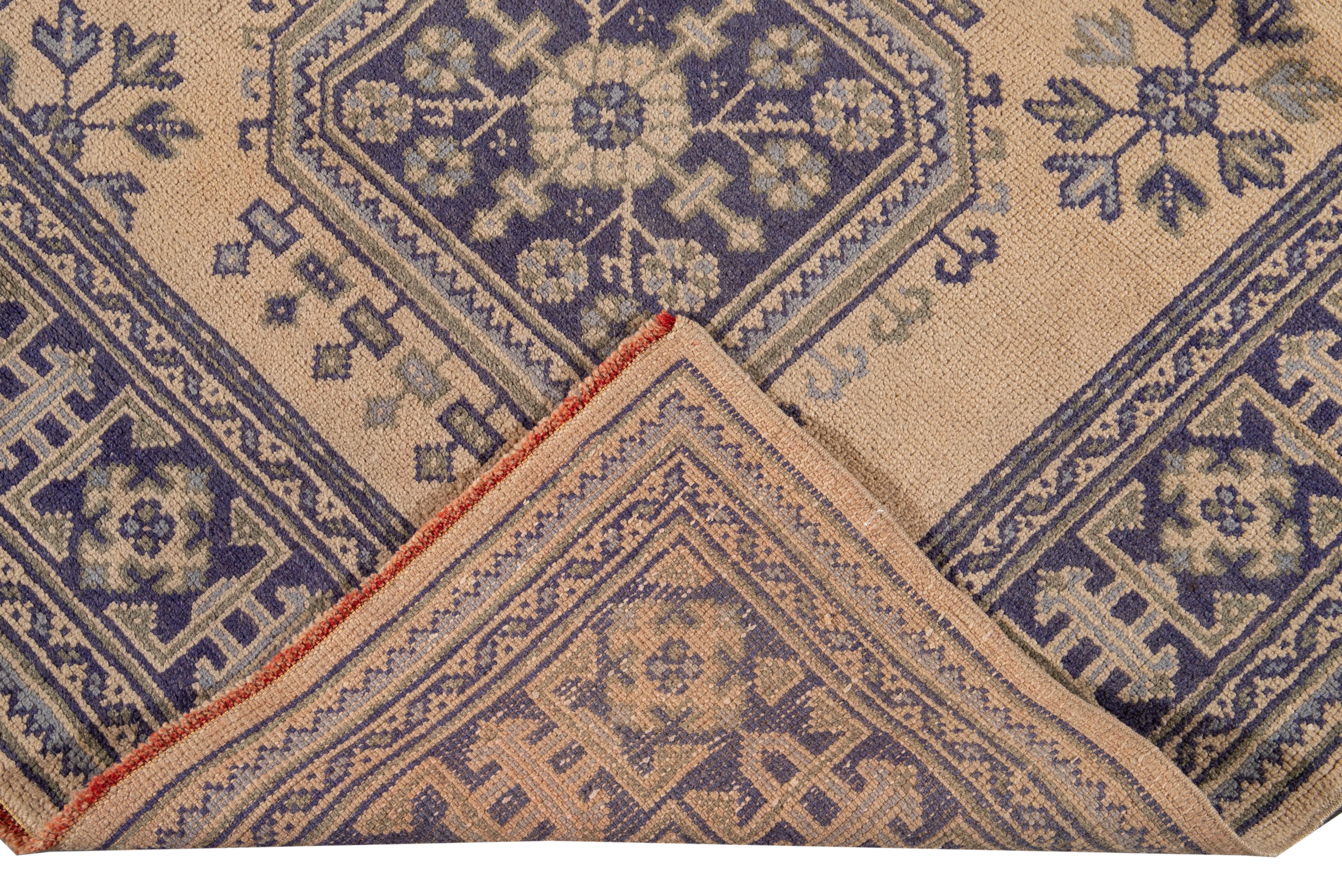 Beautiful vintage Turkish hand-knotted wool rug with a tan field. This rug has a blue border and green accents in a gorgeous all-over geometric tribal design.

This rug measures: 4'5