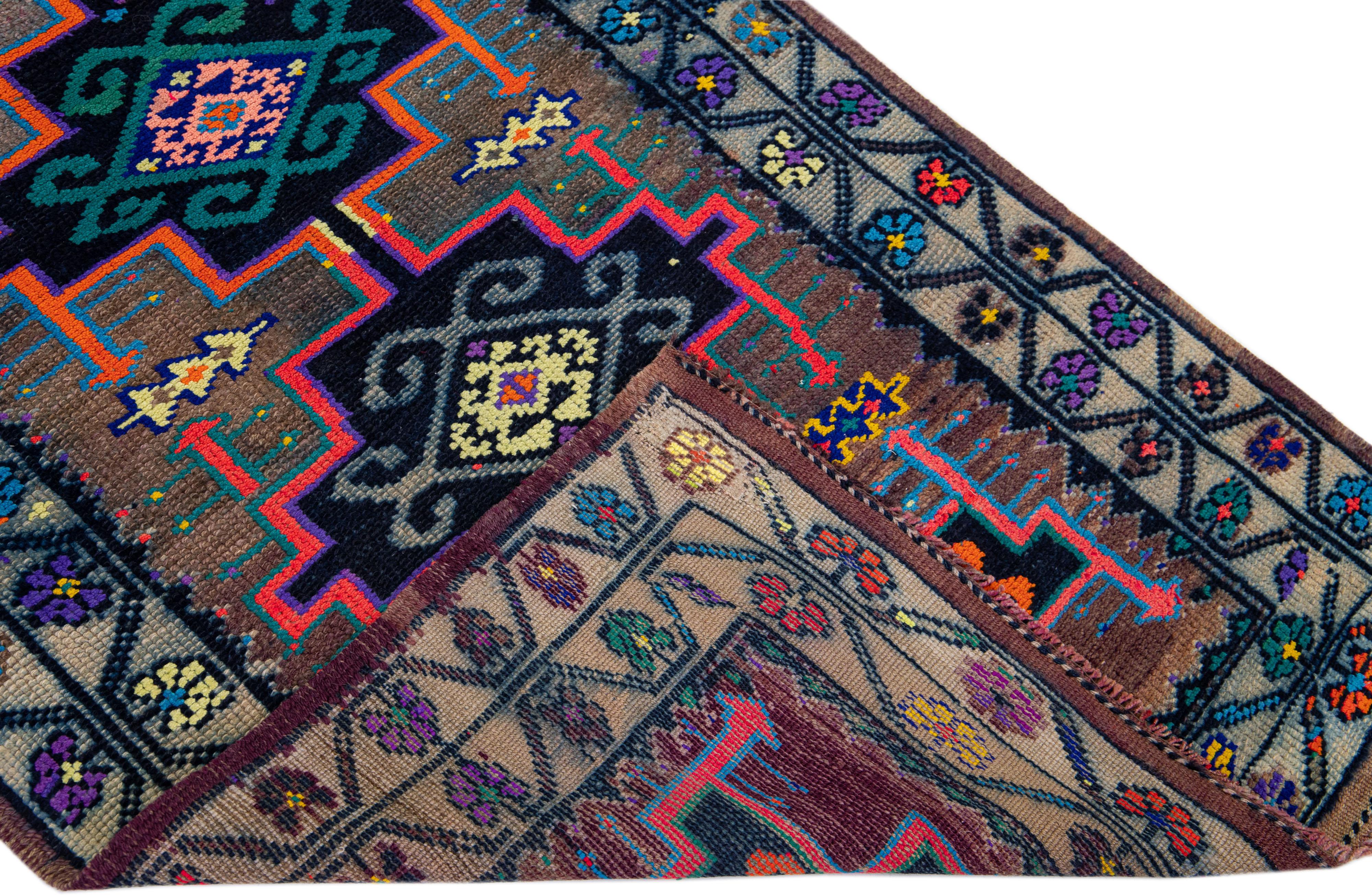Beautiful vintage hand-knotted Turkish wool rug with a brown color field. This rug has a designed frame with multicolor accents in a gorgeous all-over geometric tribal design.

This rug measures: 3'1