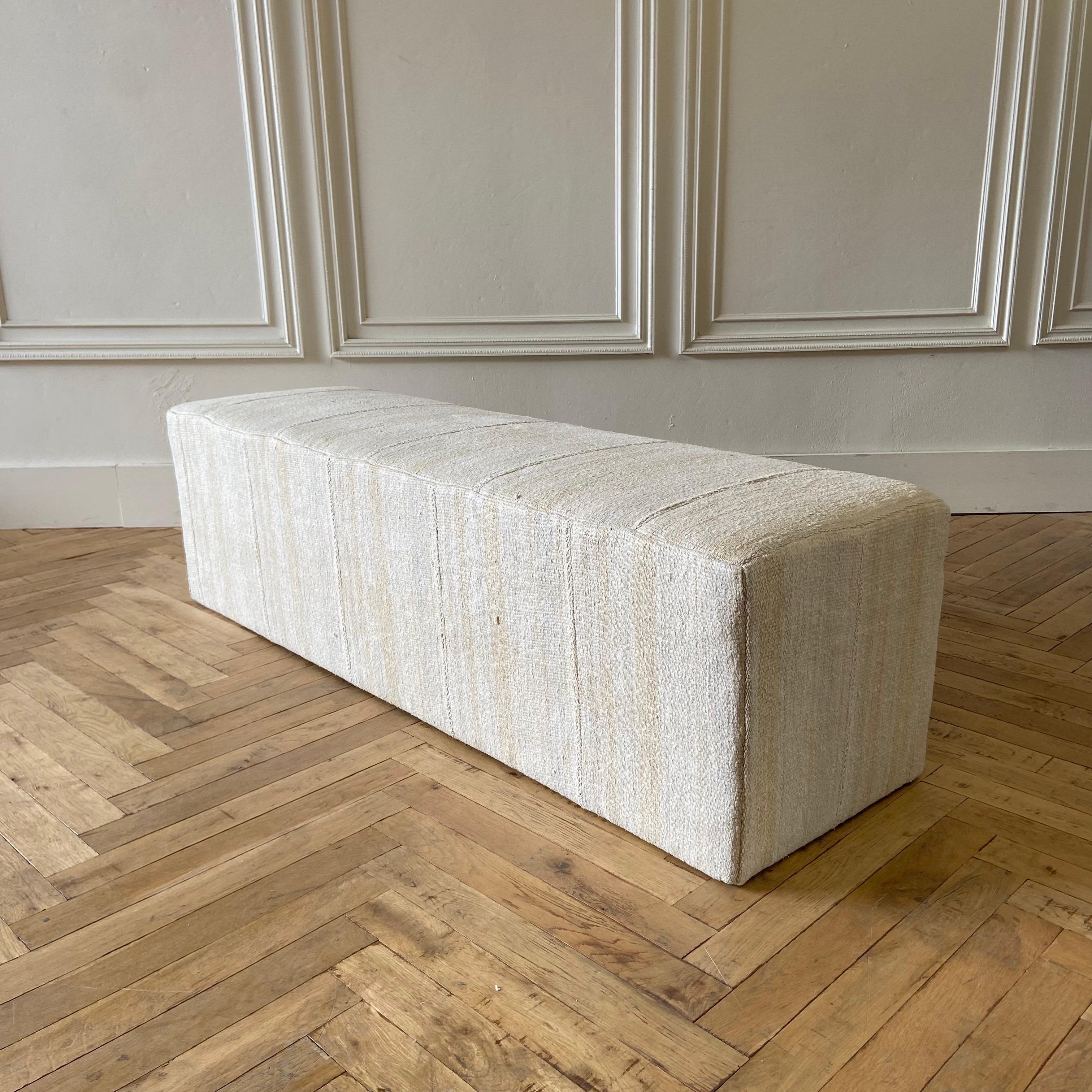 Beautiful Custom made cube ottoman 
Size: 65”W X 19”D X 18”H
Made from a vintage turkish hemp and wool rug, in an off white, with original beautiful hand tied stitched center seam, and faded taupe stripe. Taupe stripe also has a dijon coloring,