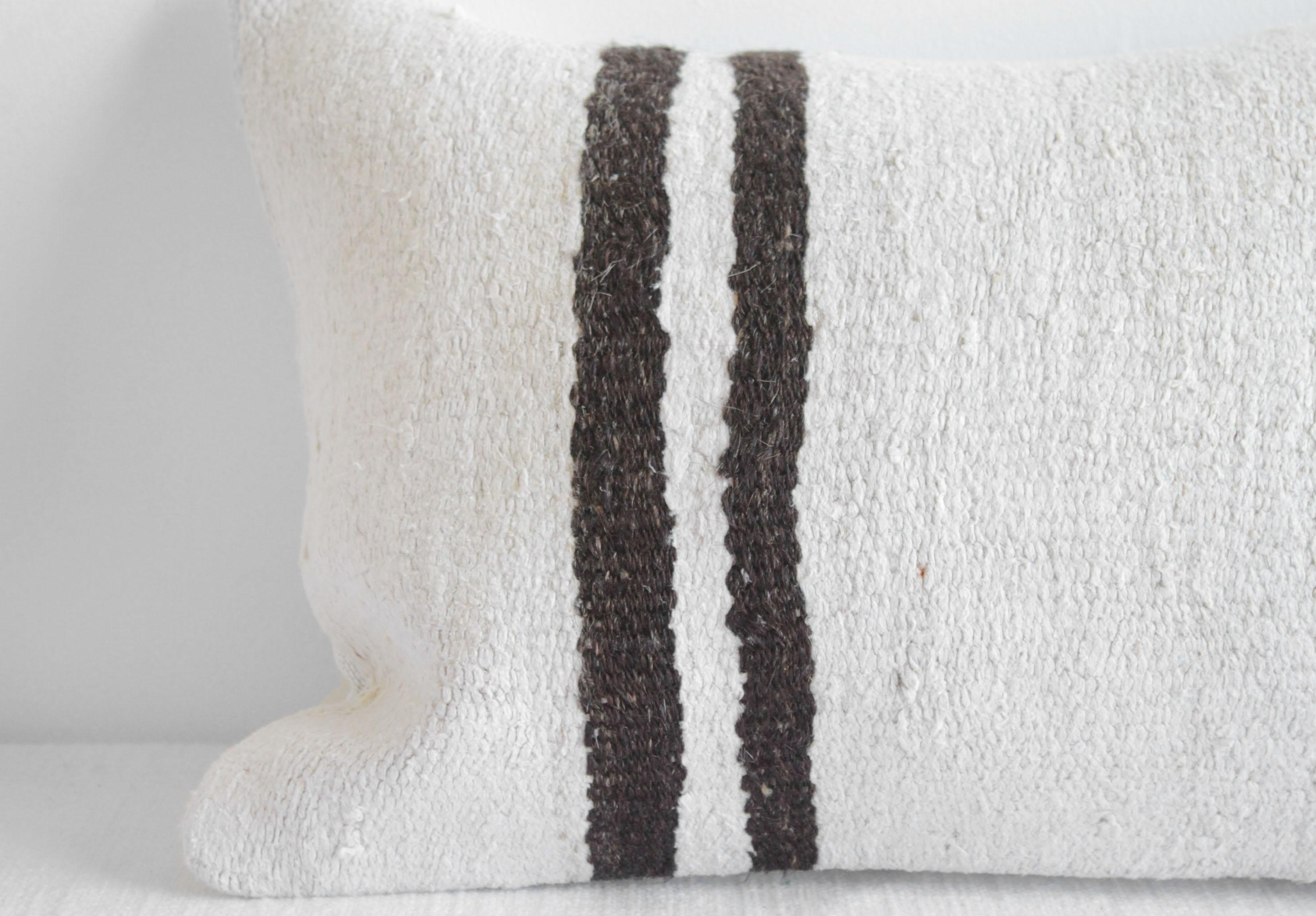Unique pillow has been made with a turkish rug, in multiple white tones, and some variations of white and brown stripes woven through. The face is fully lined, with a coordinating backing in a solid fabric, and hidden zipper closure.
Spot cleaning