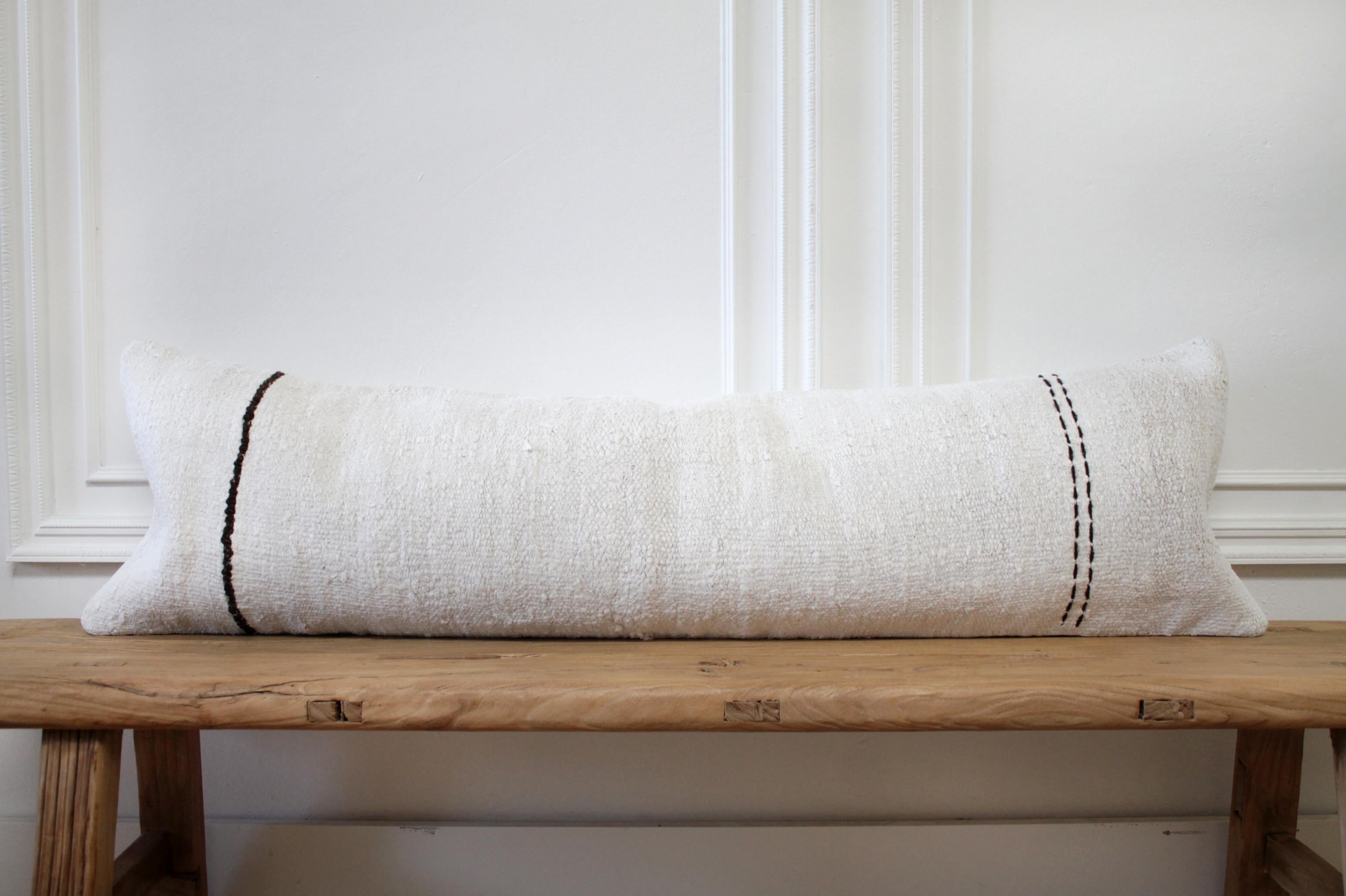 Vintage Turkish Hemp rug pillow in off white with stitched pattern on face of the pillow. This is a beautiful original hemp rug, in a white to off white color with goat hair textured minimalist stripe pattern. The backside is a coordinating fabric