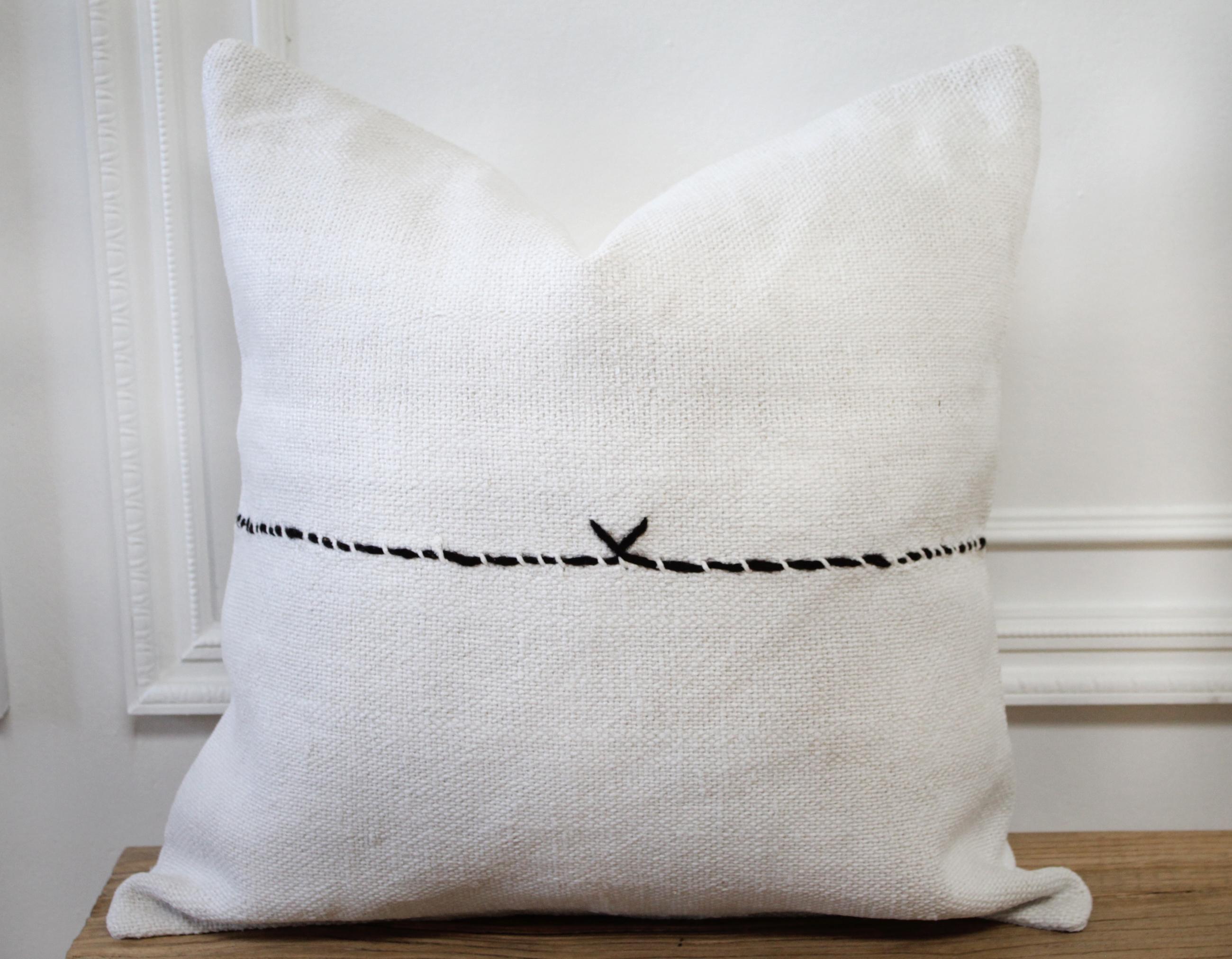 Vintage Turkish Hemp rug pillow in off-white with stitched pattern on face of the pillow. This is a beautiful original hemp rug, in a white to off-white color with goat hair textured Minimalist stripe pattern. The backside is a coordinating fabric