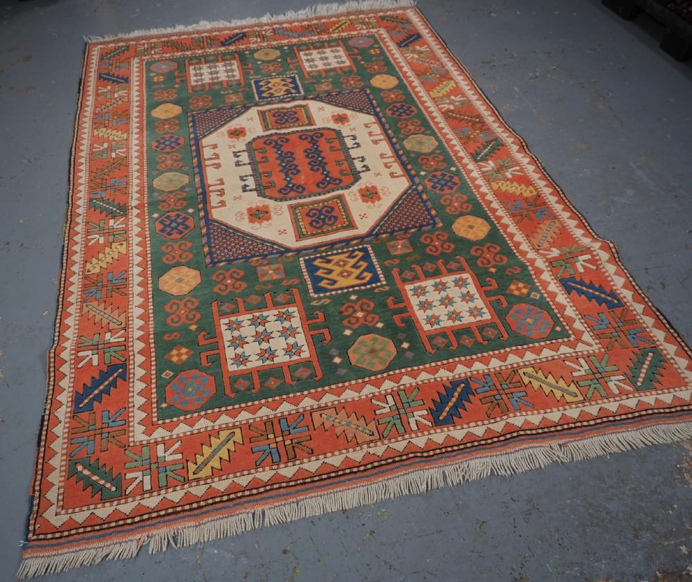 Vintage Turkish rug of the classic Karachov Kazak design, this is a well-made rug with excellent colours throughout
About 40 years old

The rug has a green ground with a soft terracotta red border

The rug is in excellent condition with very slight