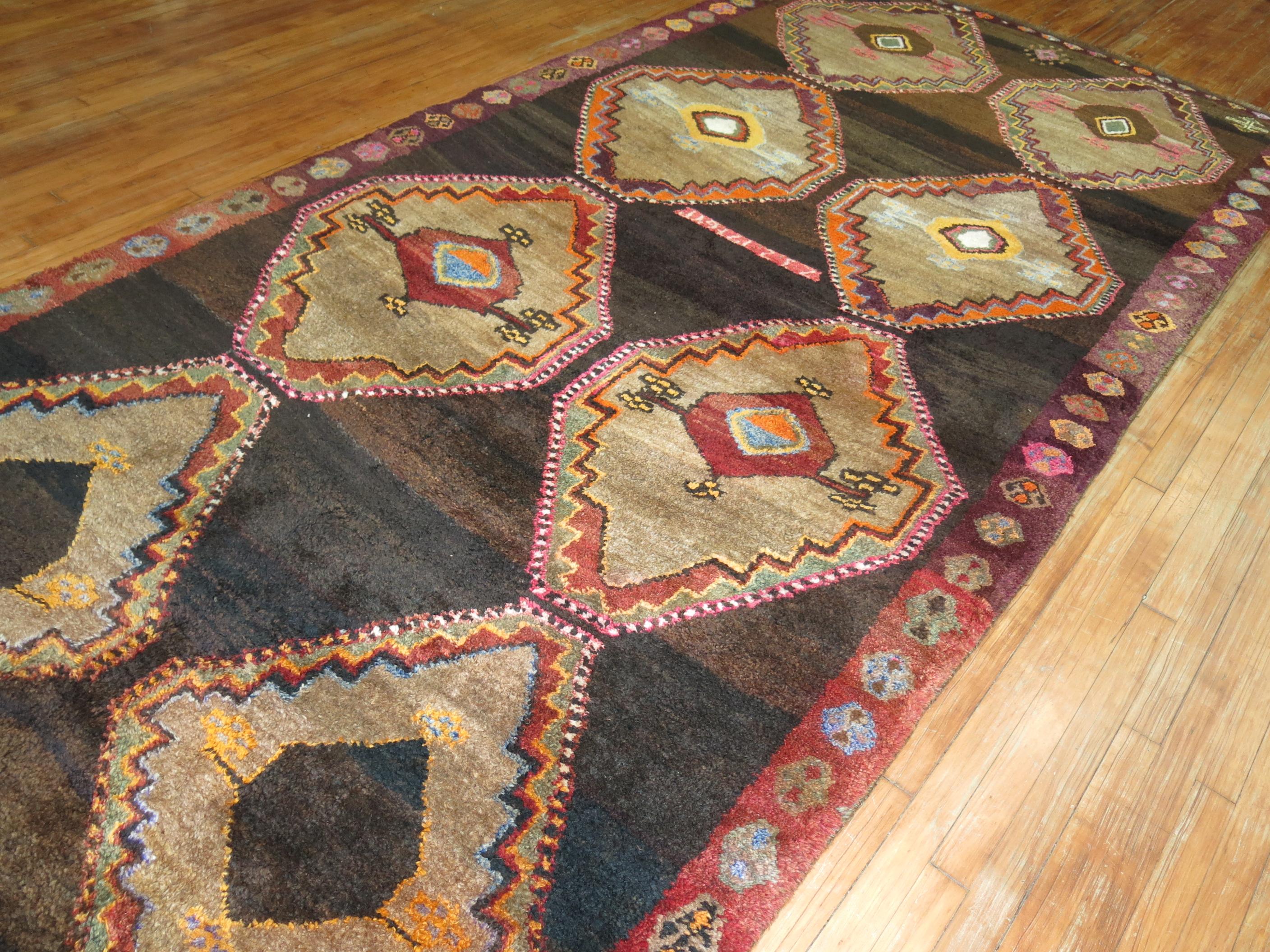 One of a kind 20th century handwoven Turkish rug from our one of a kind attitude collection. Large Bold Medallions hover over a dark brown field.