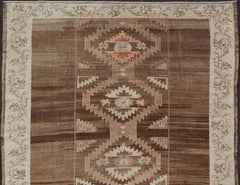Vintage Turkish Kars Rug in Brown Background with Unique Row of Medallions