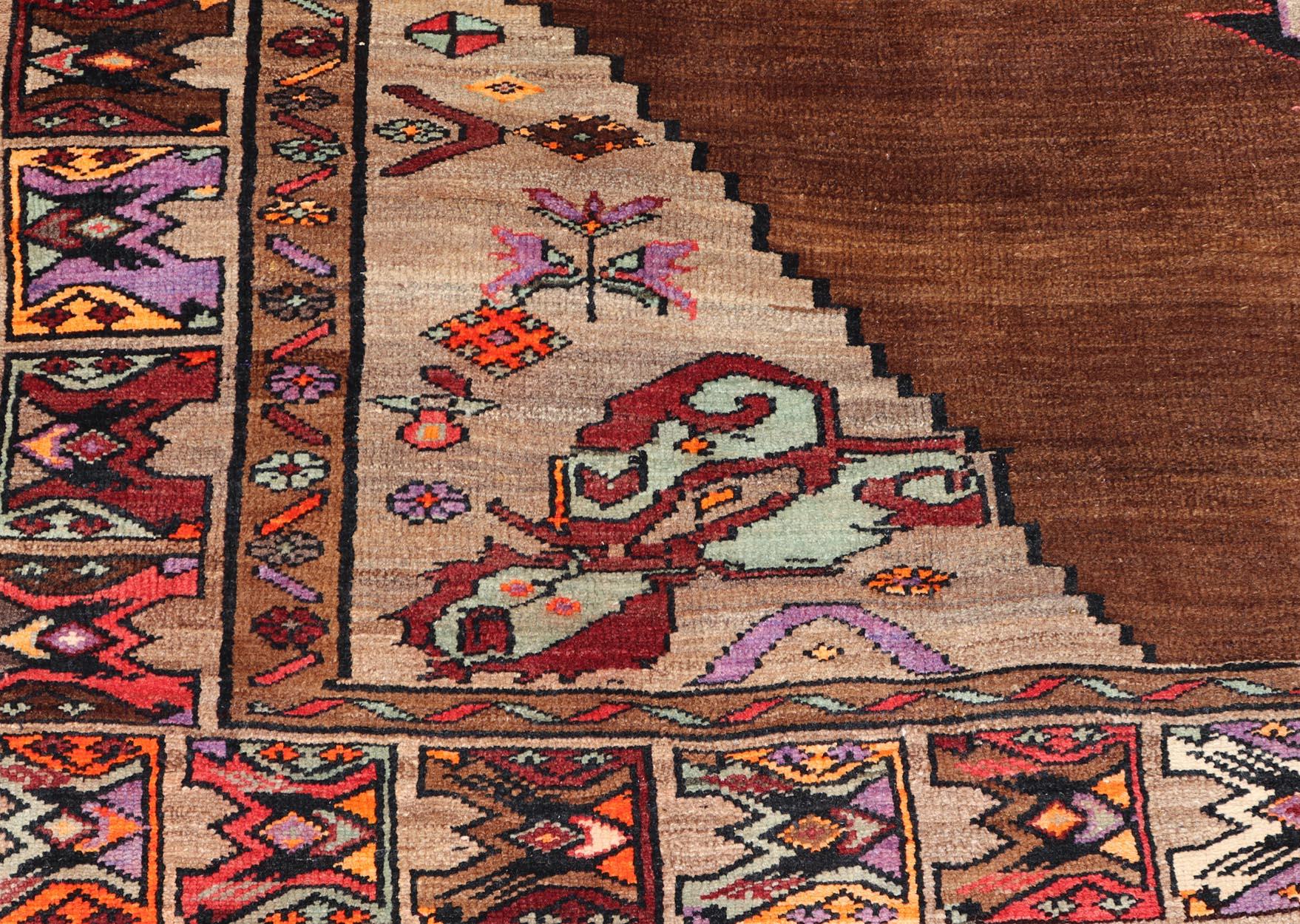 Vintage Turkish Kars Rug With Medallion On A Brown Field with Pops of Color  In Good Condition For Sale In Atlanta, GA
