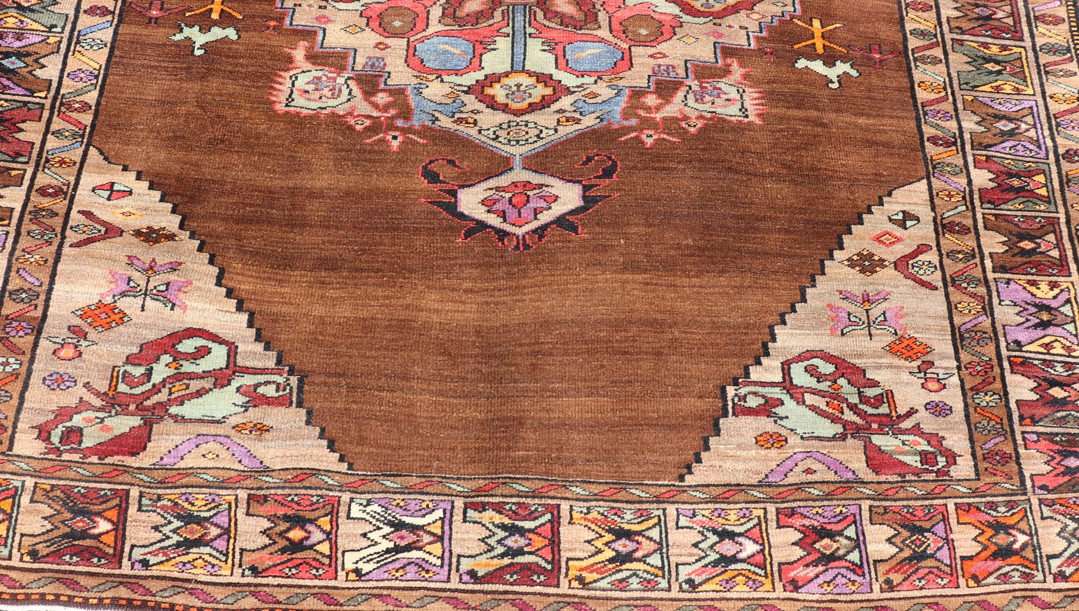 20th Century Vintage Turkish Kars Rug With Medallion On A Brown Field with Pops of Color  For Sale