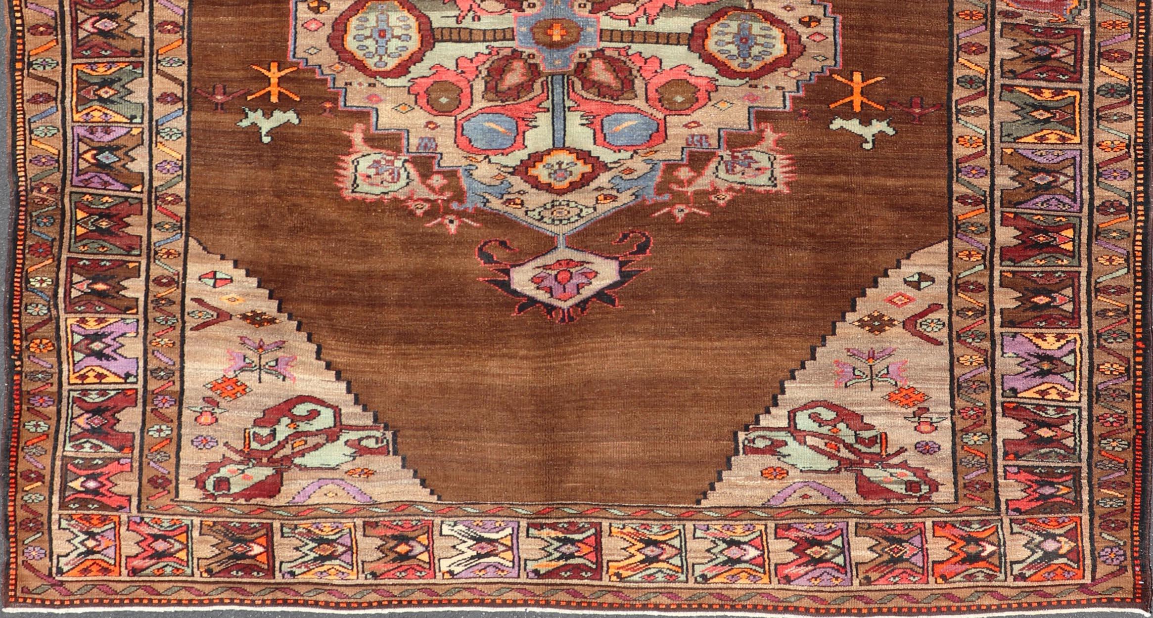 Wool Vintage Turkish Kars Rug With Medallion On A Brown Field with Pops of Color  For Sale