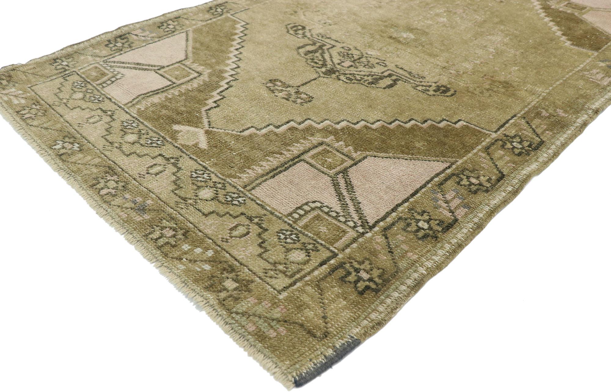 52701, vintage Turkish Kars rug with Romantic Mid-Century Modern style. This hand knotted wool vintage Turkish Kars rug features a cusped central medallion anchored with palmette pendants on either end floating in an open abrashed cut-out field.