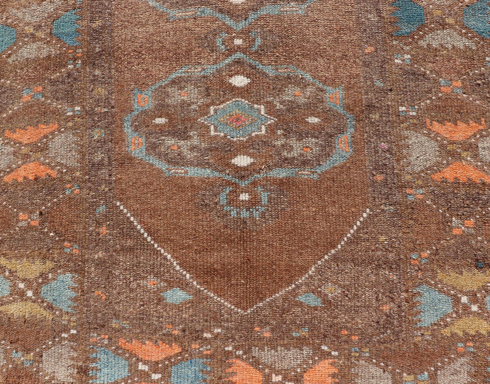 Vintage Turkish Kars runner in brown color, tan, taupe and soft orange. Keivan Woven Arts / rug EN-P13239, country of origin / type: Turkey / Kilim, circa Mid-20th Century.

This vintage runner features an assortment of tribal and geometric