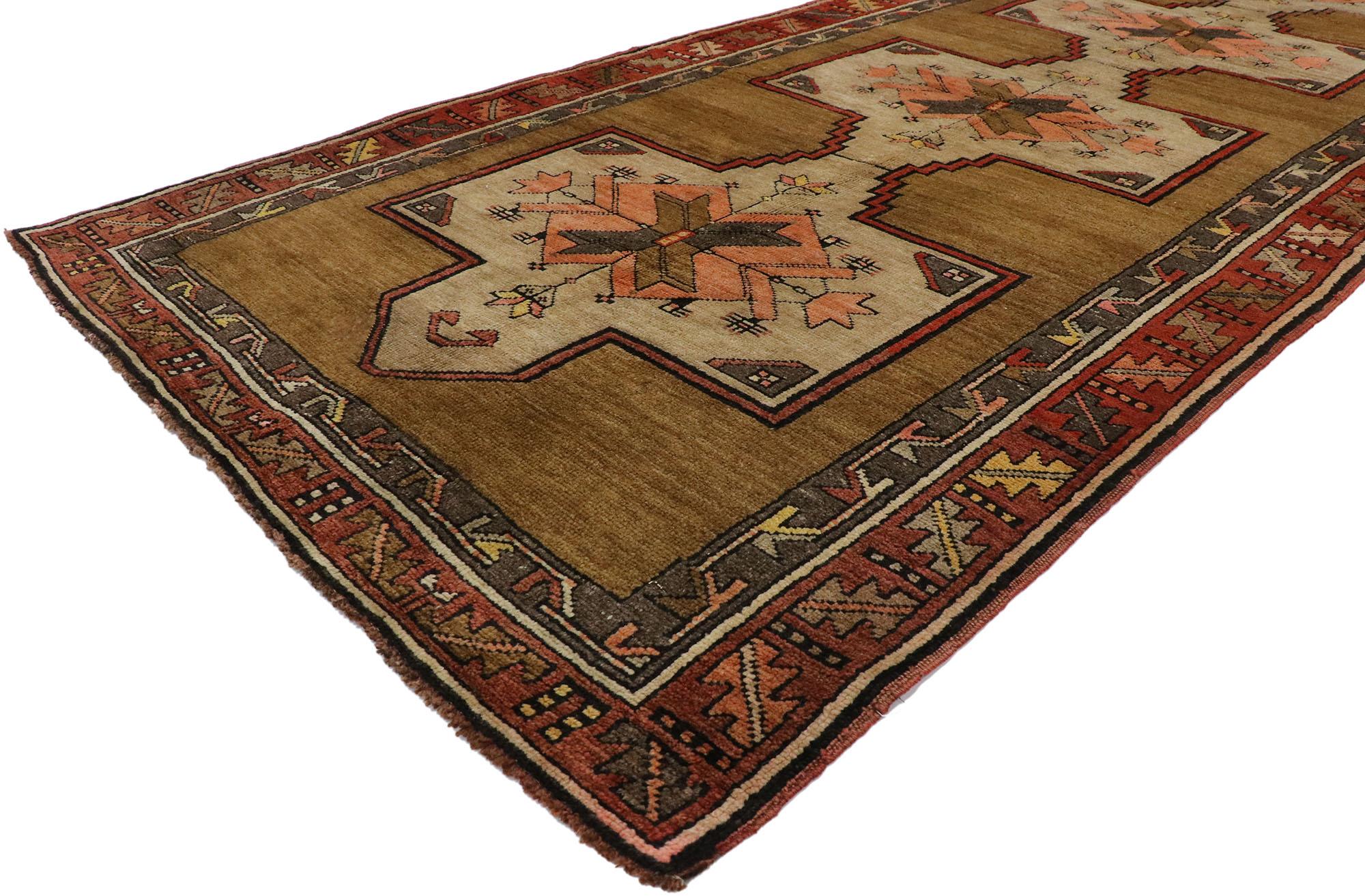 ?53397 Vintage Turkish Kars Runner with Mid-Century Modern style. ??With its luminous warm hues and beguiling beauty, this hand knotted wool vintage Turkish Kars runner will take on a curated lived-in look that feels timeless while imparting a sense