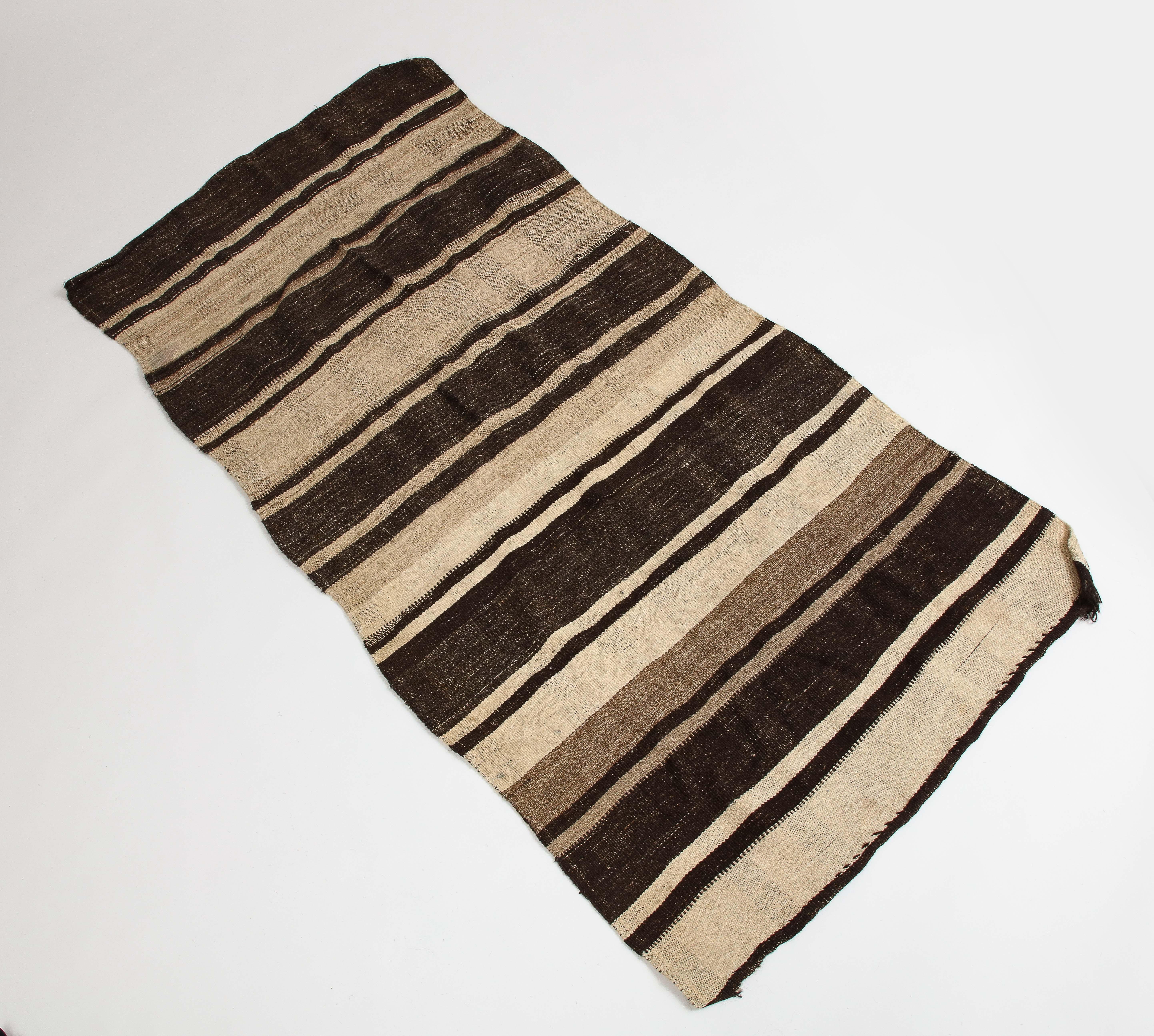 Vintage Turkish kilim brown striped wool rug.