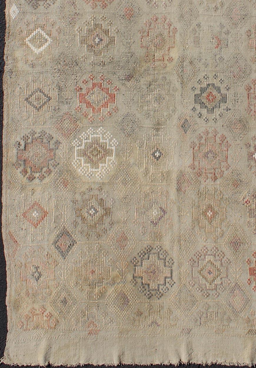 Hand-Woven Vintage Turkish Kilim Featuring Muted Colors and All-Over Tribal Motif Design For Sale