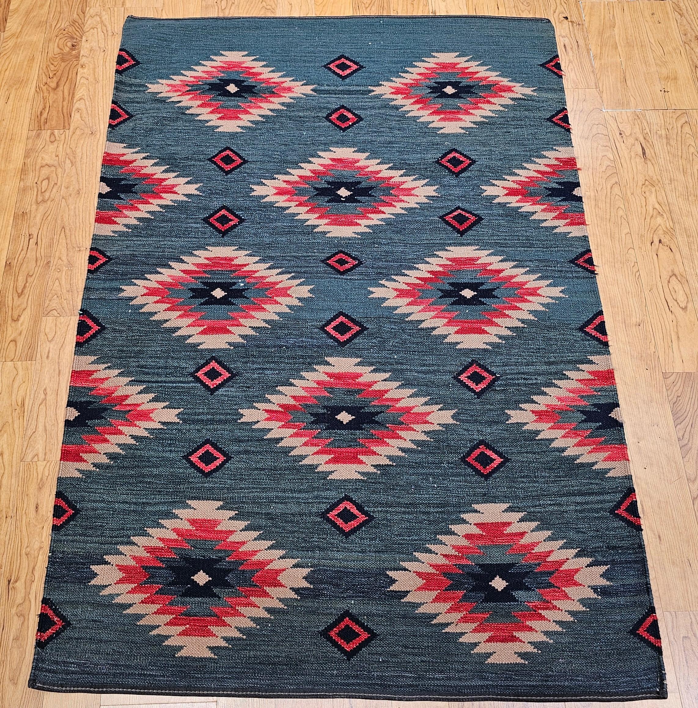 Add a touch of timeless Southwestern charm to your space with this vintage handwoven kilim rug, inspired by the geometric patterns of Navajo rugs from the Southwestern United States and northern Mexico. Woven in the third quarter of the 20th