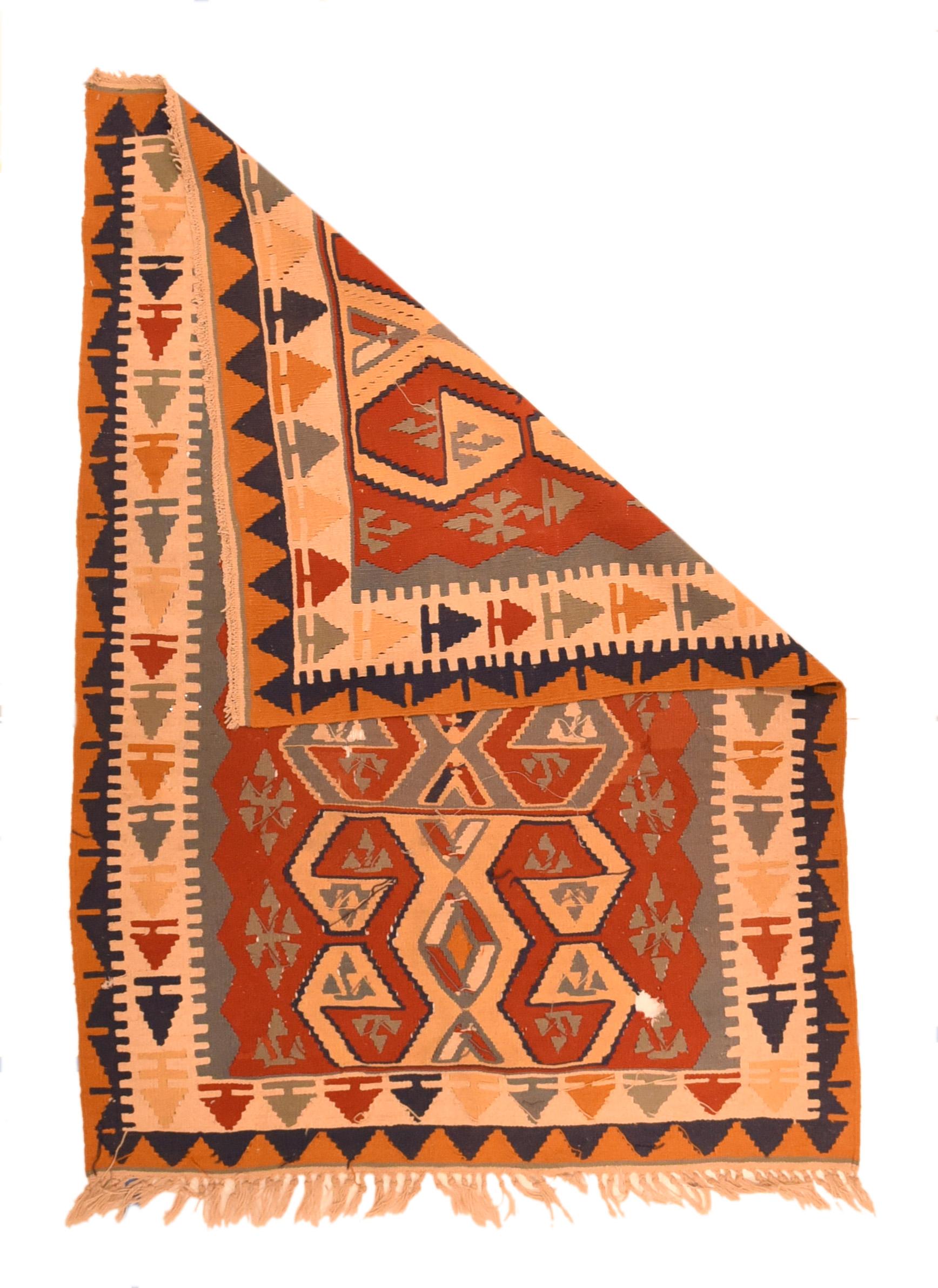 Vintage Turkish Kilim Rug 3'2'' x 5'3''. This moderately woven, slit-tapestry piece shows a rust-red field displaying three stacked giant hooked lozenges in green and straw. Green zig-zag triangle border on sides. Main ecru border of variously