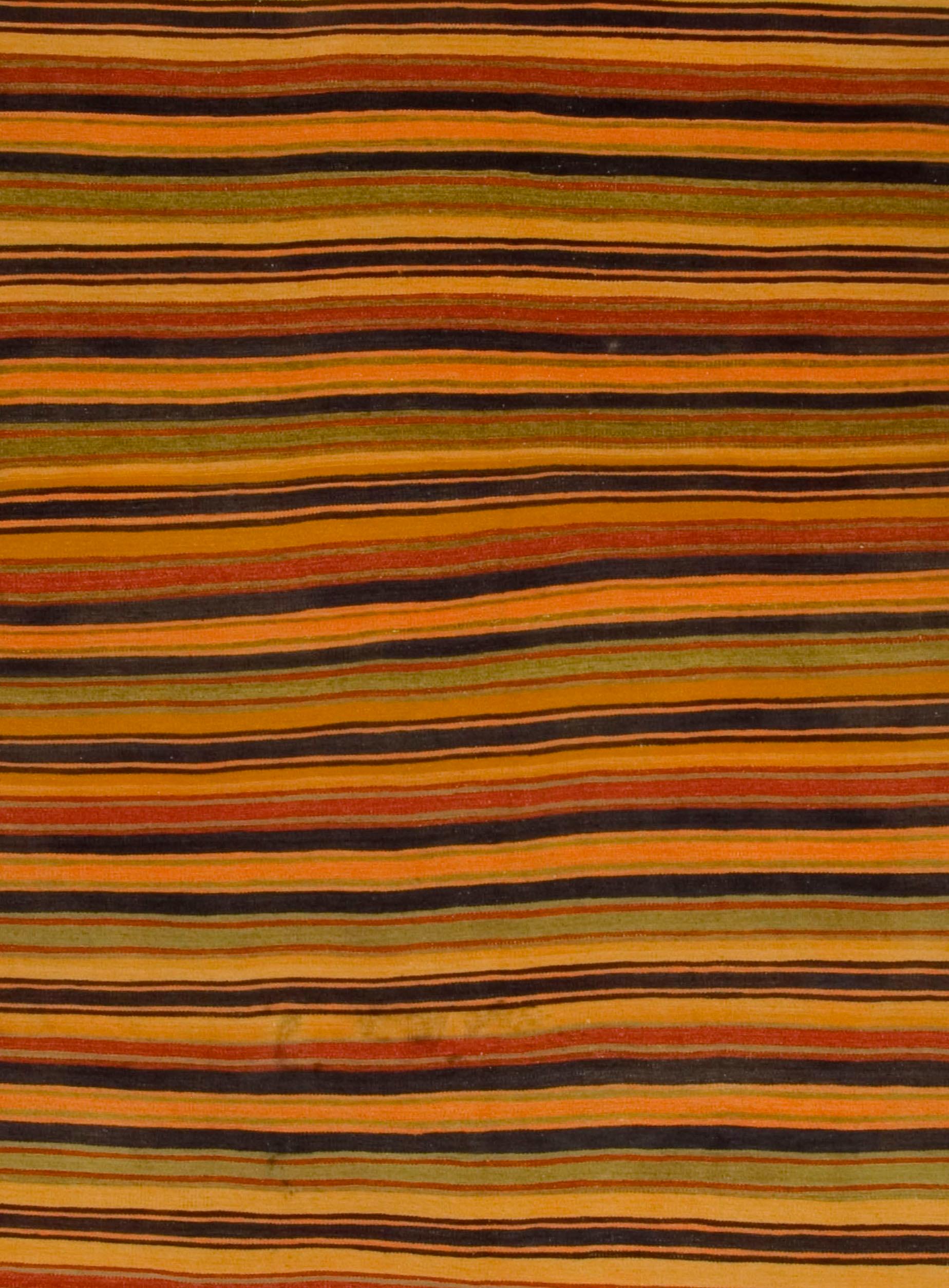 Vintage Turkish Kilim rug. Vintage striped Turkish Kilim handwoven in the 1950s. The simplicity and boldness of these pieces can also give a contemporary feel and can look at home in both a modern or traditional setting. Colors: gold/orange/multi.