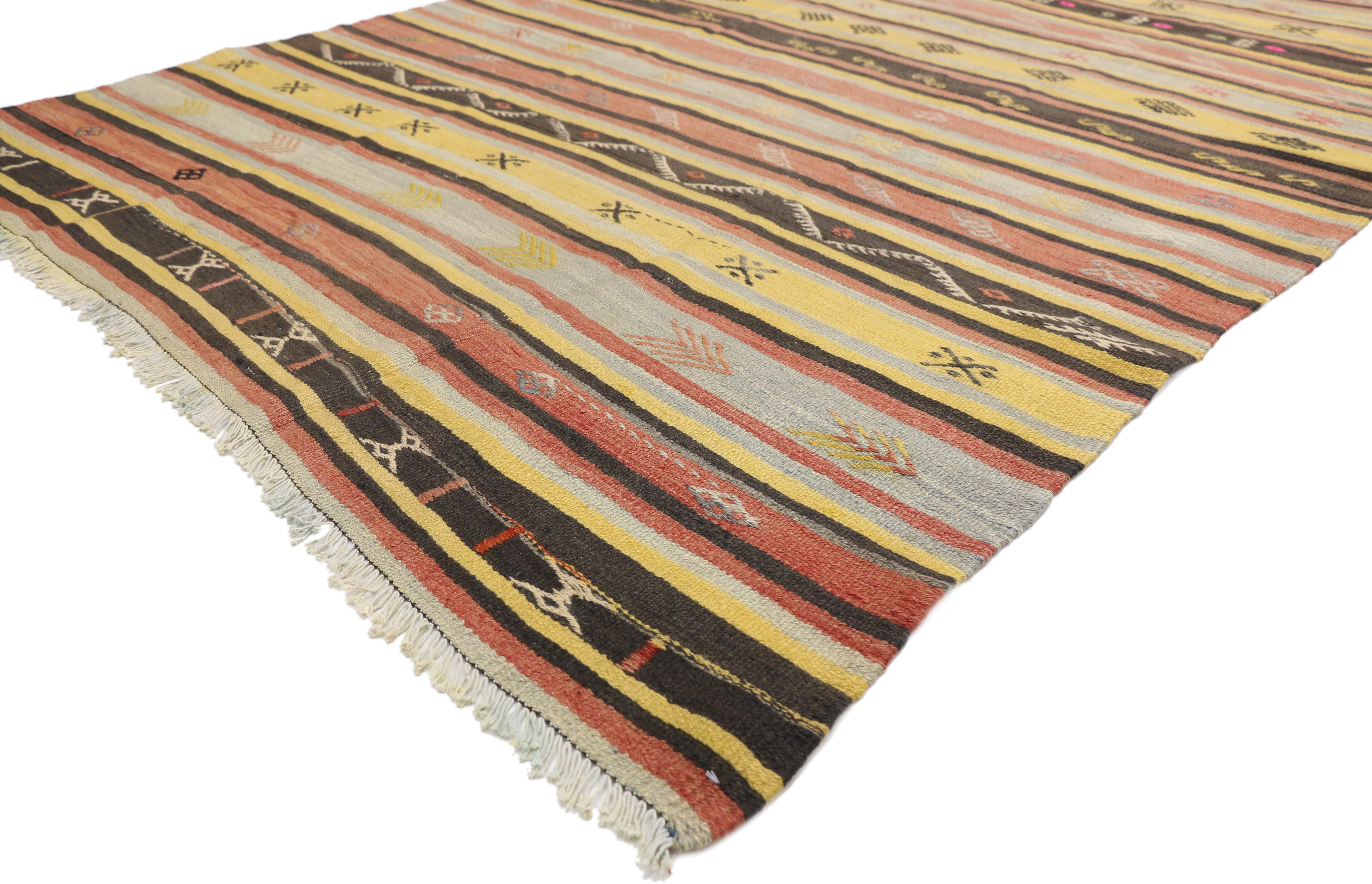 51280, vintage Turkish Kilim rug, flat-weave Kilim Tribal rug. This handwoven wool vintage Turkish Kilim rug features alternating bands composed of ancient tribal motifs and stripes. This Kilim rug is rich in Turkish culture, as the symbolic motifs