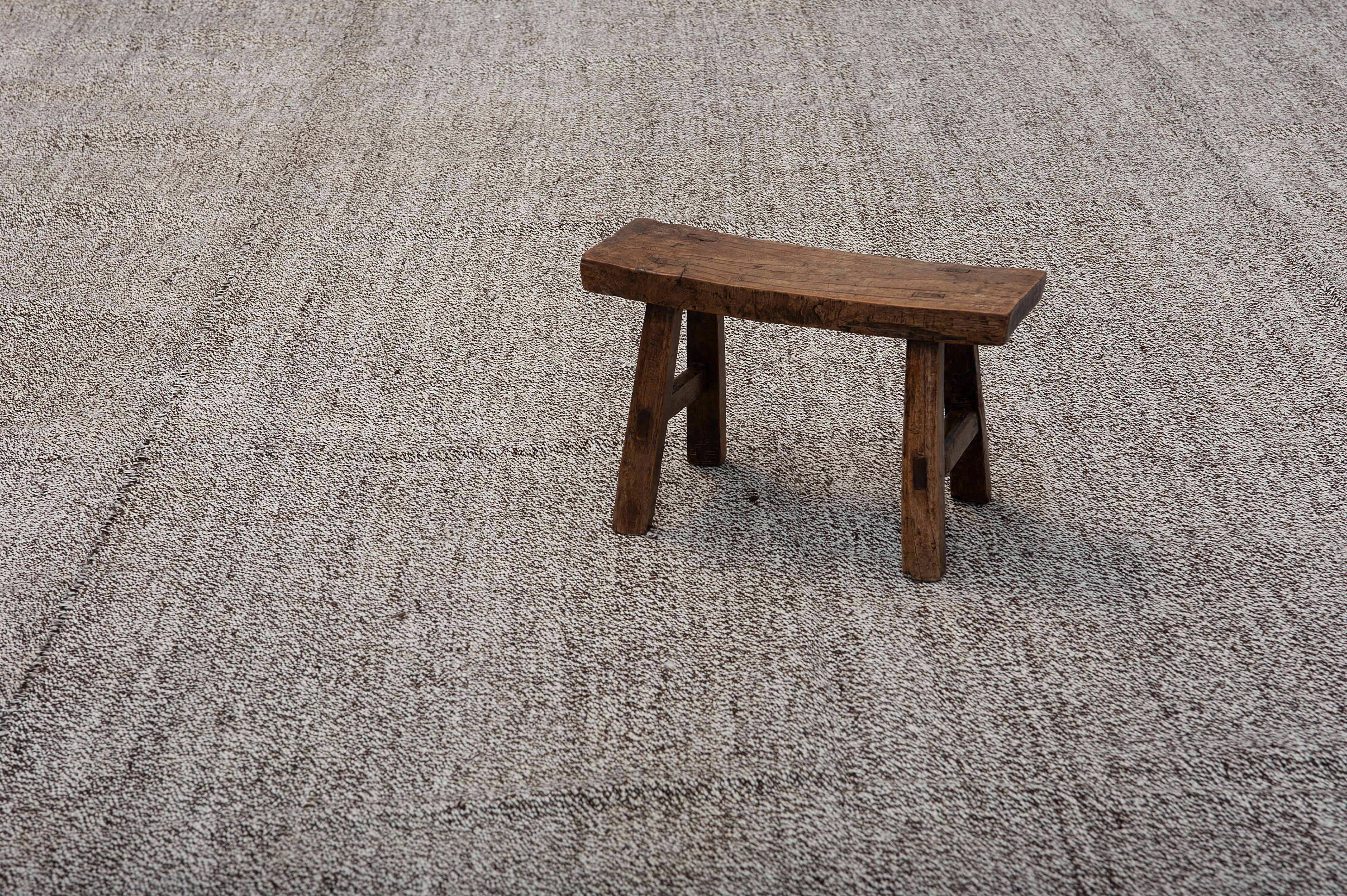These large vintage Kilim in a shade of grayish-earthy tone is an excellent canvas for different design aesthetics. From Minimalist, Scandinavian, rustic, boho chic, any imaginable style would be complemented beautifully by these flat-weave. Well