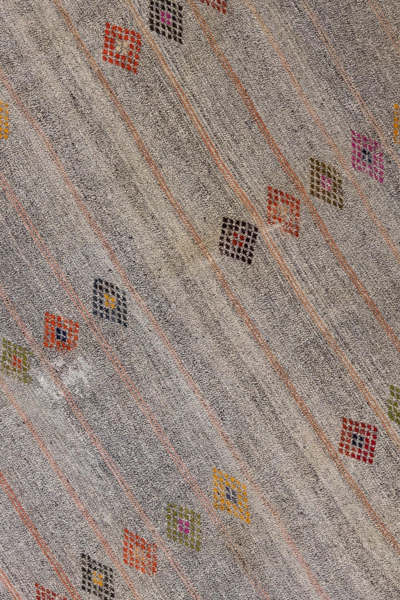 Age: Circa 1950

Colors: gray, magenta, yellow, brown, red

Pile: flatweave

Wear Notes: 0

Material: goat hair. 

Midcentury Anatolian chaput flatweave rug with fun pops of color. Great for layering.

Wear Guide:
Vintage and antique