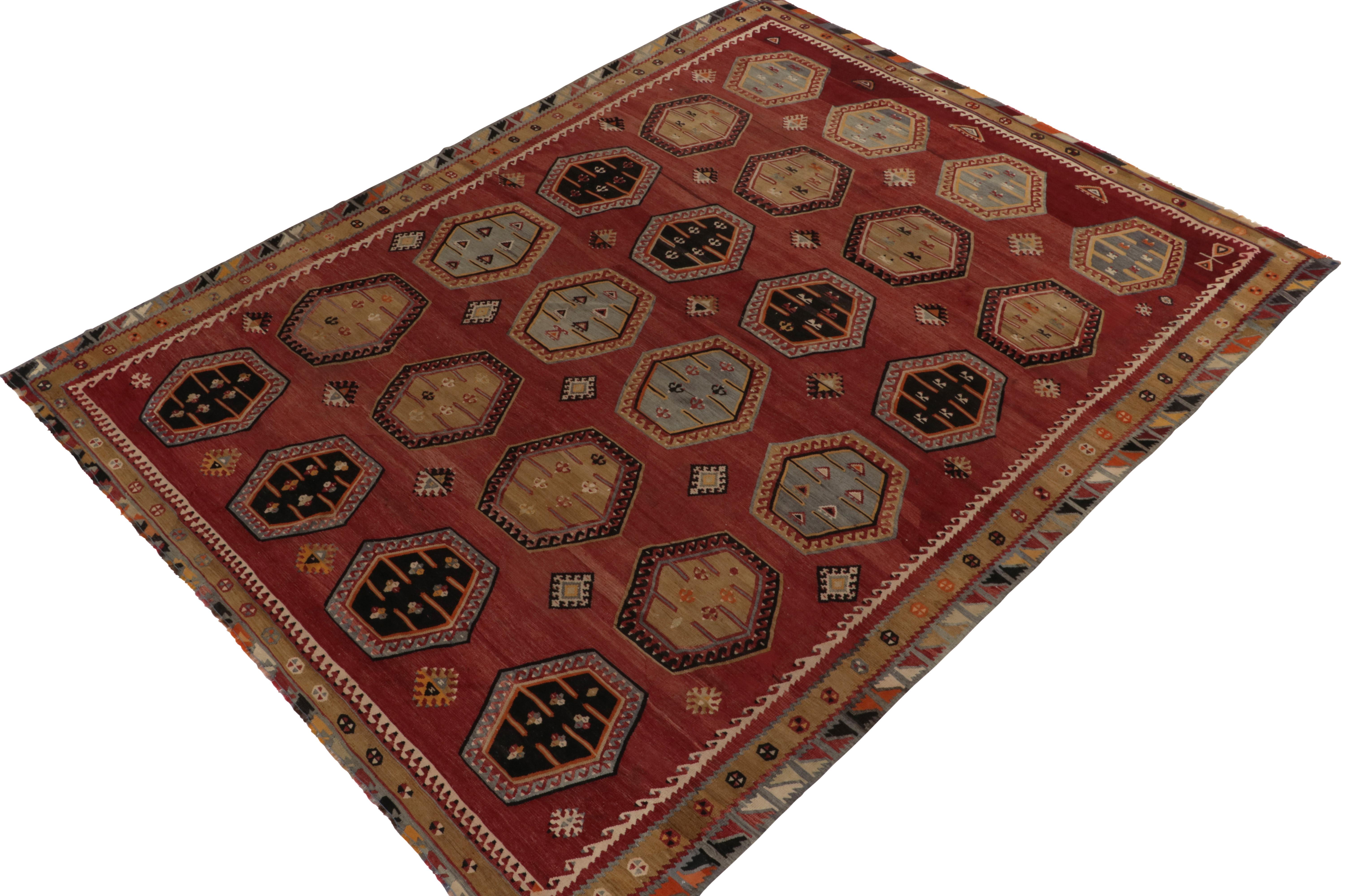Originating between 1950-1960, a rare 8x11 vintage kilim rug believed to hail from mid-century Anatolia in Turkey. 

Handwoven in wool, the tones of red, beige-brown and blue play harmoniously together for a rustic tribal appeal in the field’s