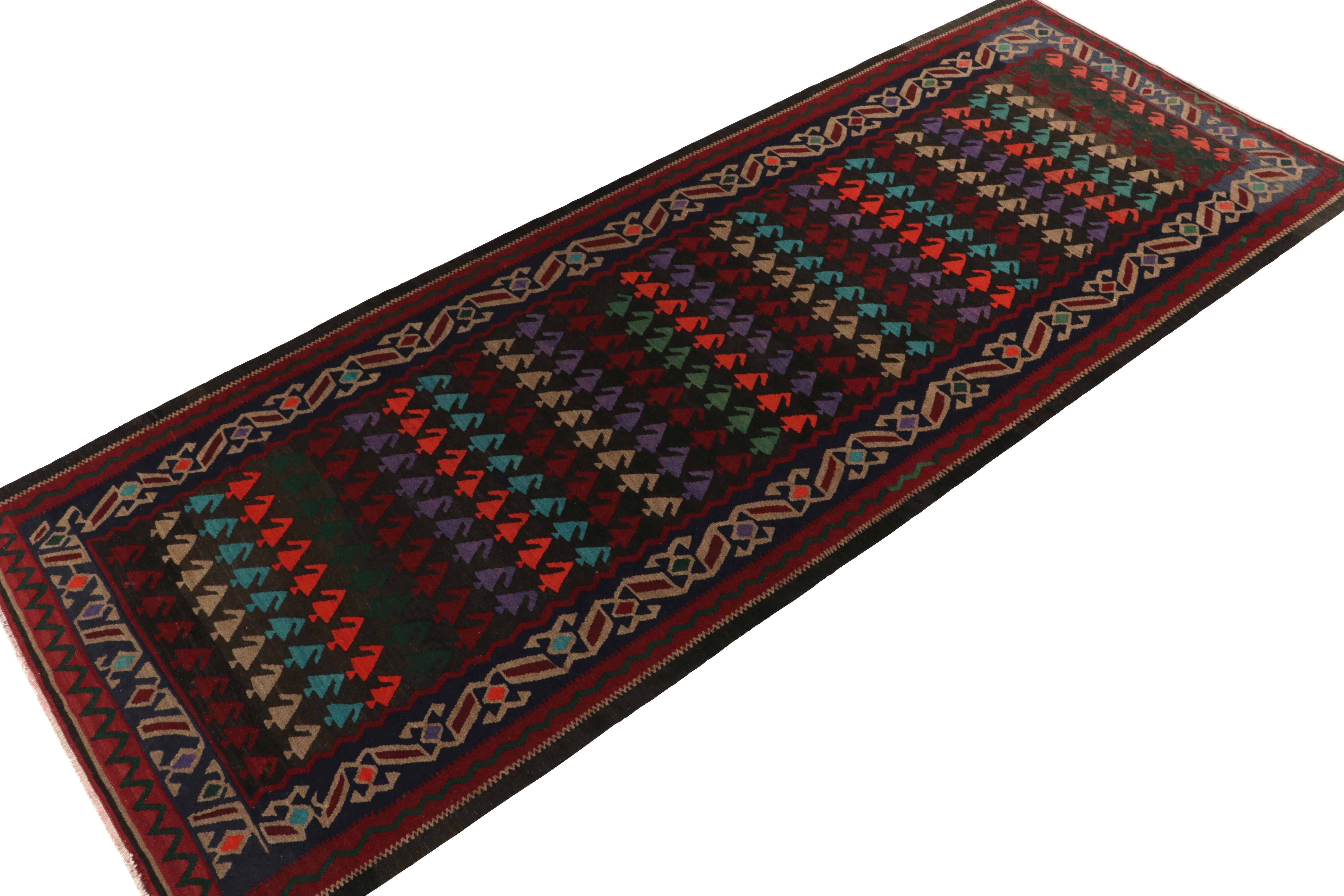 Handwoven in fine wool, a 5x13 vintage kilim runner from Turkey, now joining our Kilim & Flatweave collection. A unique piece of folk art from the mid-century, the gracious scale reflects an intriguingly colorful field pattern in red, near-black,