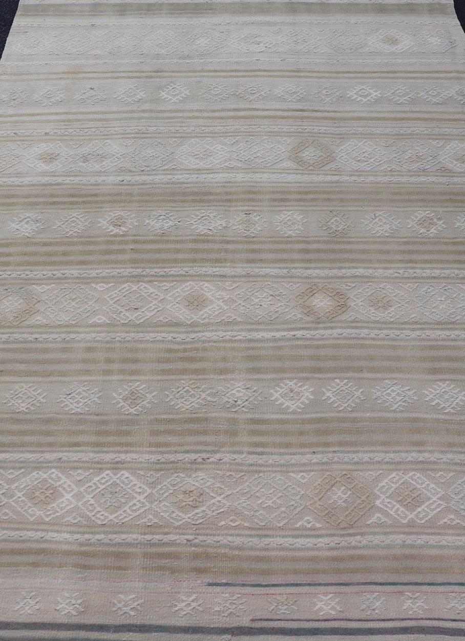 Measures: 5'2 x 8'3 
Vintage Turkish Kilim Rug With Earthy Tones and Geometric Patterns 5'2 x 8'3. Keivan Woven Arts / Rug / EN-15529 Country of origin / type: Turkey / Kilim
 
The geometric patterns woven throughout the rug add depth and character,