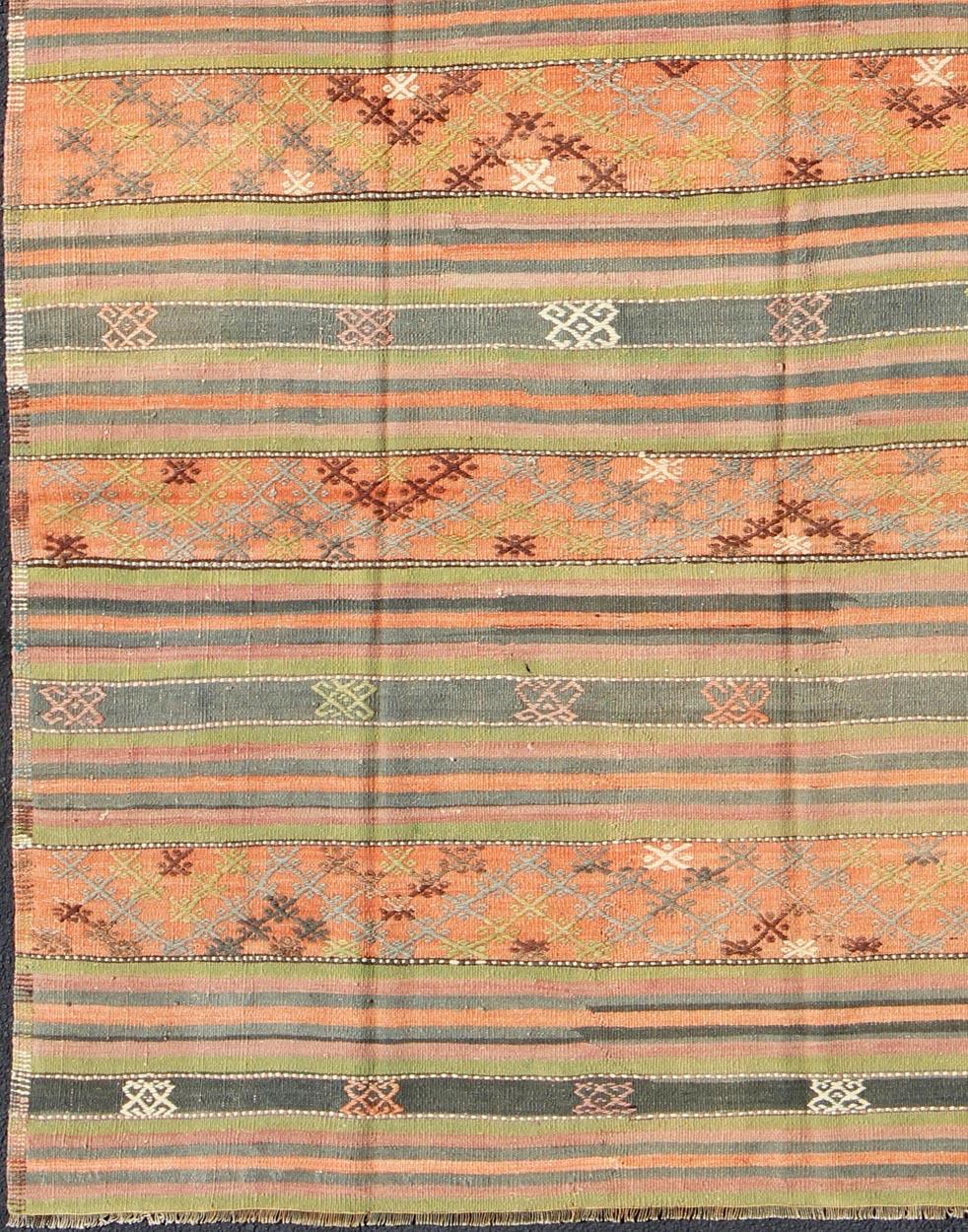 Vintage Turkish Kilim rug with geometric shapes and colorful stripes, rug ned-28, country of origin / type: turkey / Kilim, circa mid-20th century

Featuring geometric shapes rendered in a repeating horizontal stripe design, this unique