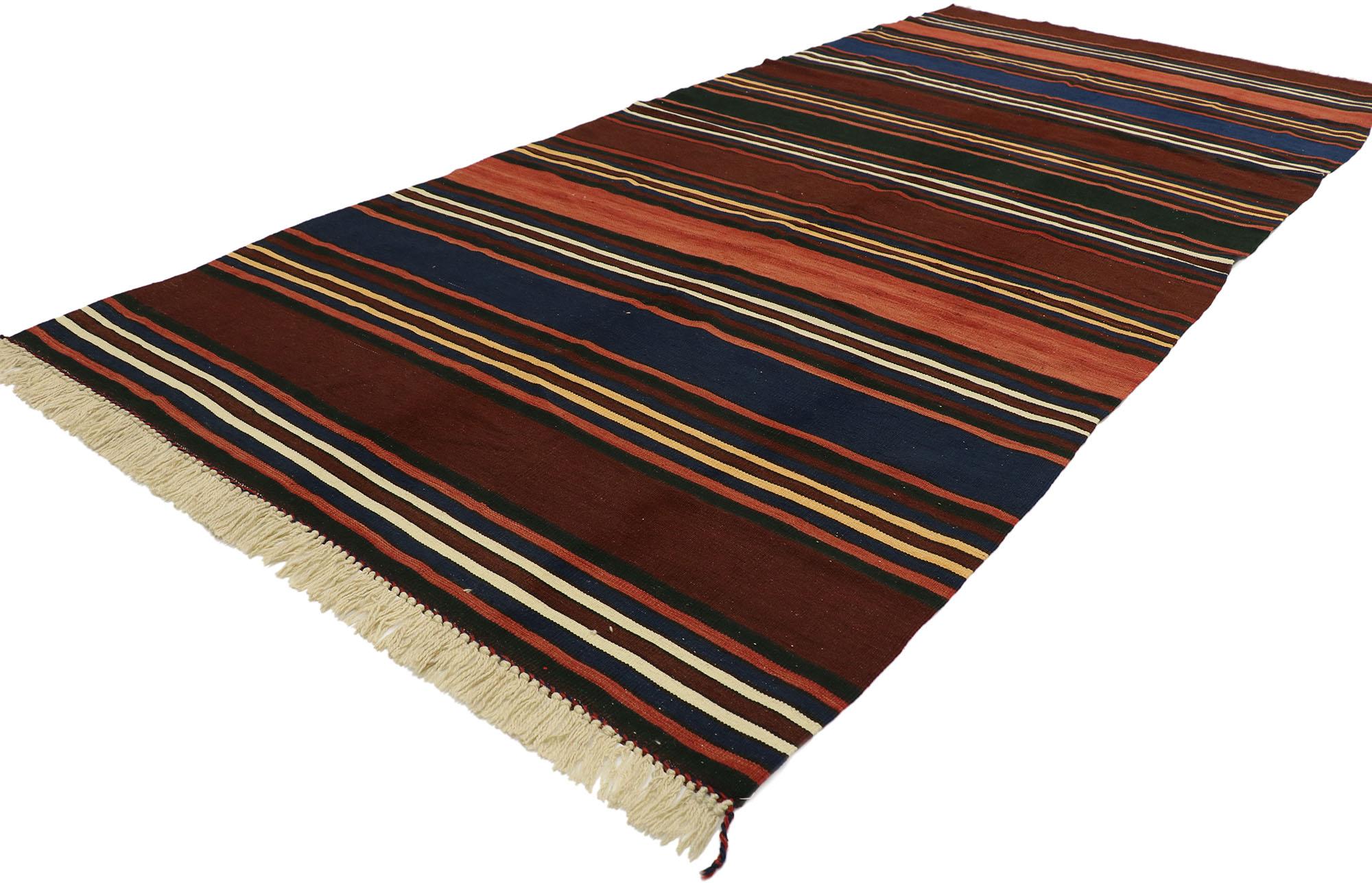 53120 vintage Turkish Kilim rug with Modern Cabin Adirondack style. With its warm hues and rugged beauty, this handwoven wool striped kilim rug manages to meld contemporary, modern, and traditional design elements. The flat-weave kilim rug features