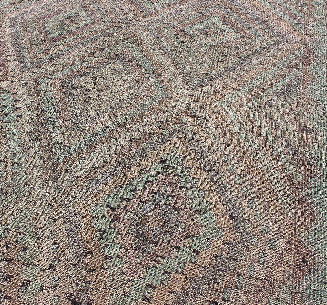 Measures: 6'10 x 10'8 
Vintage Turkish Kilim Rug with Soft Geometric Diamond Pattern in Muted Pastel. Keivan Woven Arts / rug/TU-EMD-95008, country of origin / type: Turkey / Kilim, circa 1950. 

This vintage Turkish Kilim rug features a finely
