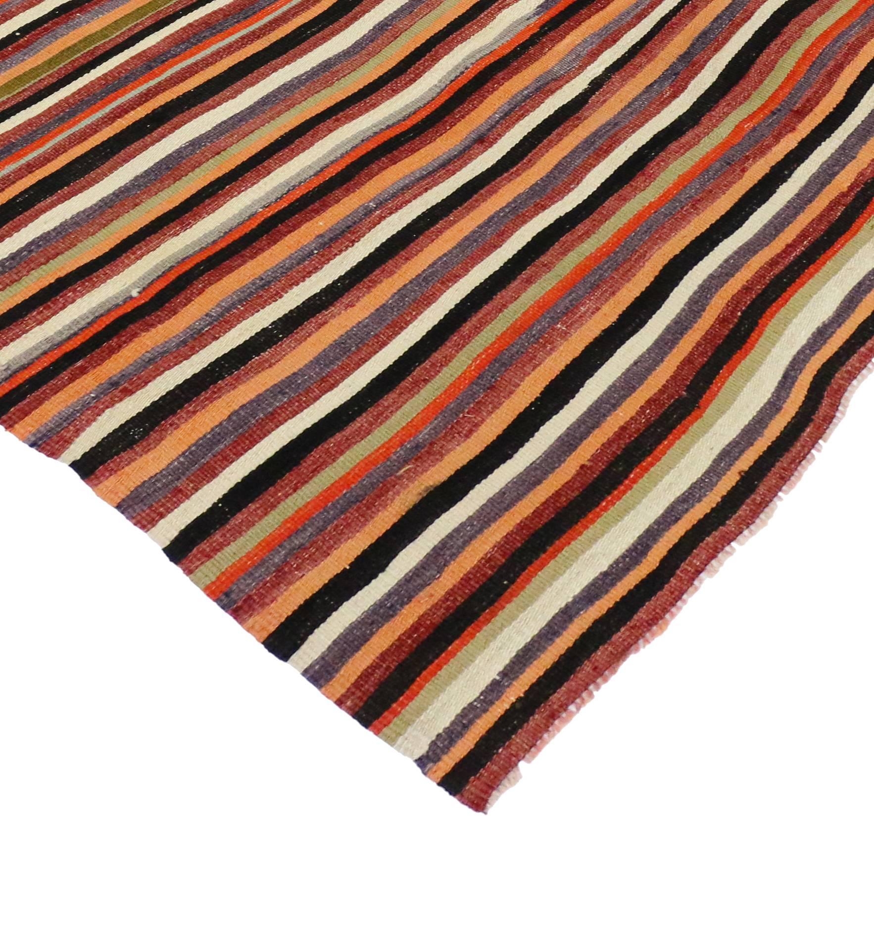 74871, vintage Turkish Kilim rug with stripes. This handwoven wool vintage Turkish kilim rug features alternating stripes rendered in variegated shades of dark red, orange, ivory, violet, light green, peach, mint, buff, olive and black. The