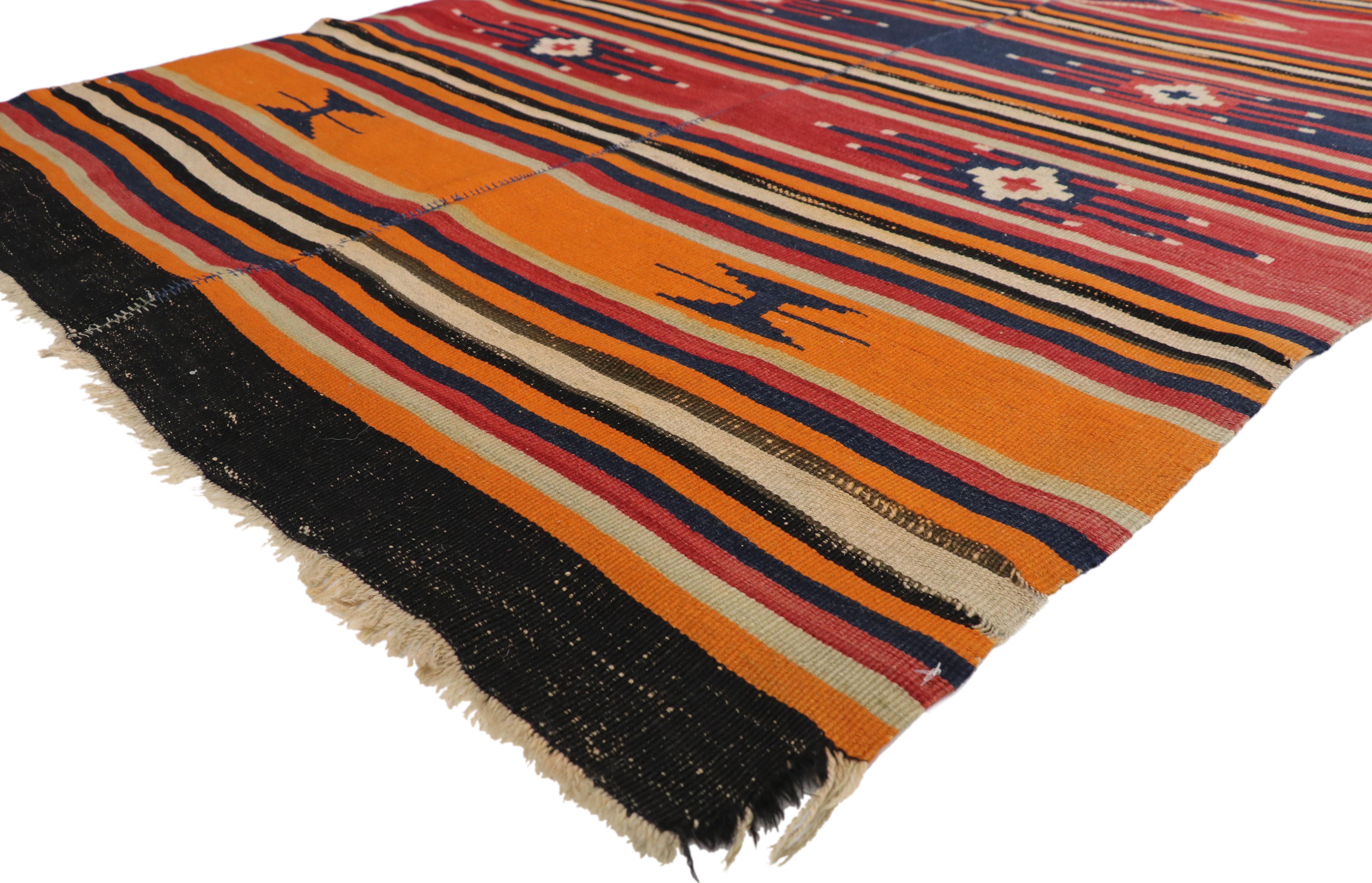 73172, vintage Turkish Kilim rug with Tribal style. Made by Turkish artisans in the 1940s and features wide and narrow bands of bold colors with secondary protection symbols. Rendered in orange, red, dark blue, black, brown and creamy beige. The