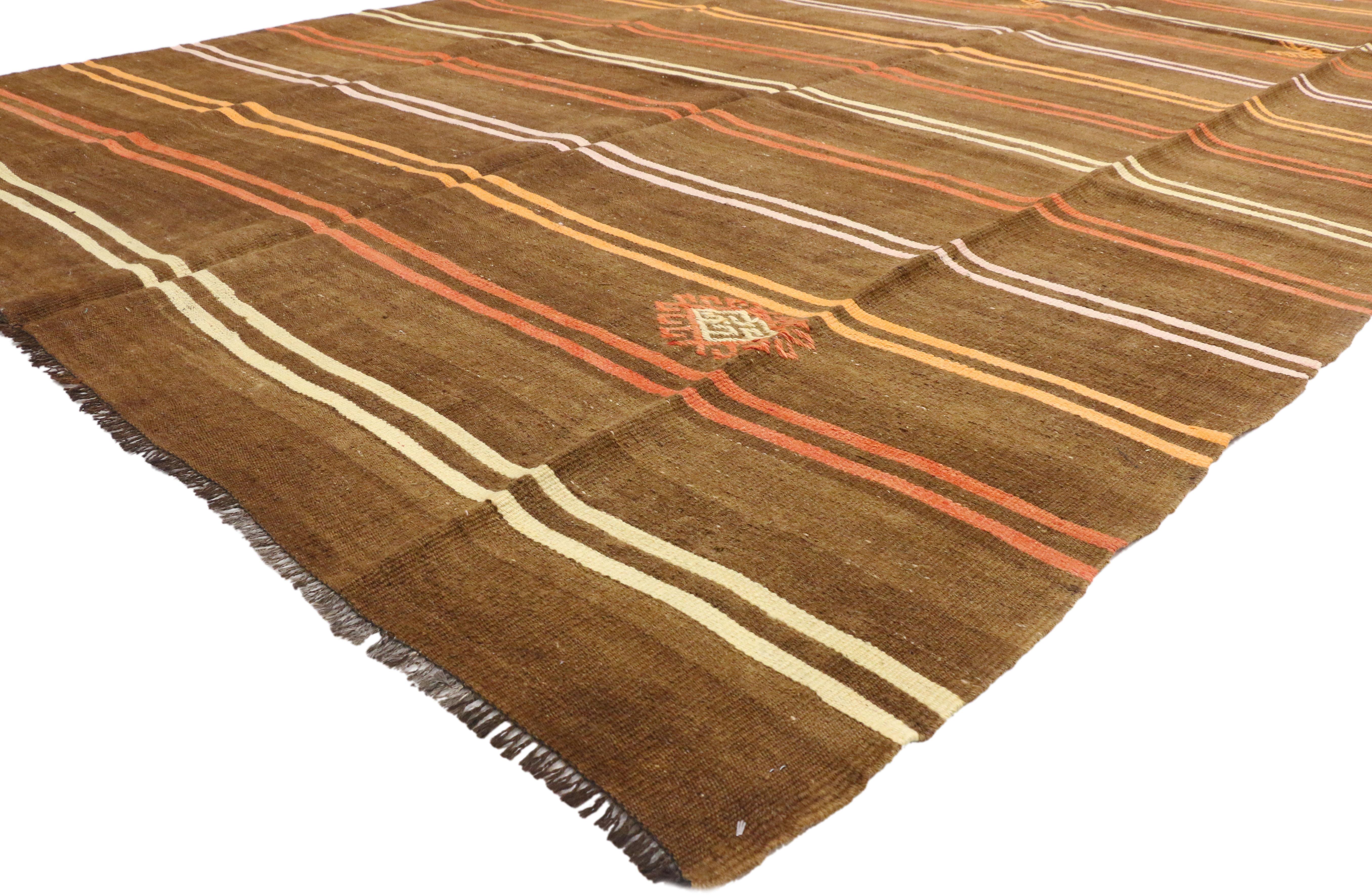 51076 Vintage Turkish Kilim Rug with Bohemian Tribal Design and Modern Cabin Style. Create a comfortable and modern setting with this hand-woven wool vintage Turkish Kilim rug. The flat-weave kilim rug features symbolic tribal motifs and vibrant