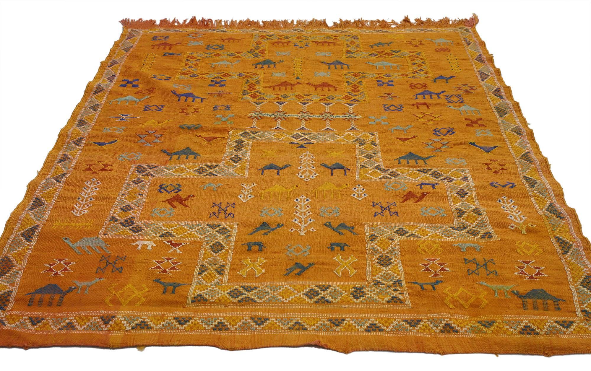76988, vintage Turkish Kilim rug with tribal style, small flat-weave. This handwoven wool vintage Turkish Kilim rug features an array of geometric tribal motifs, including camels and the three of life. Intricate, colorful and full of ancient