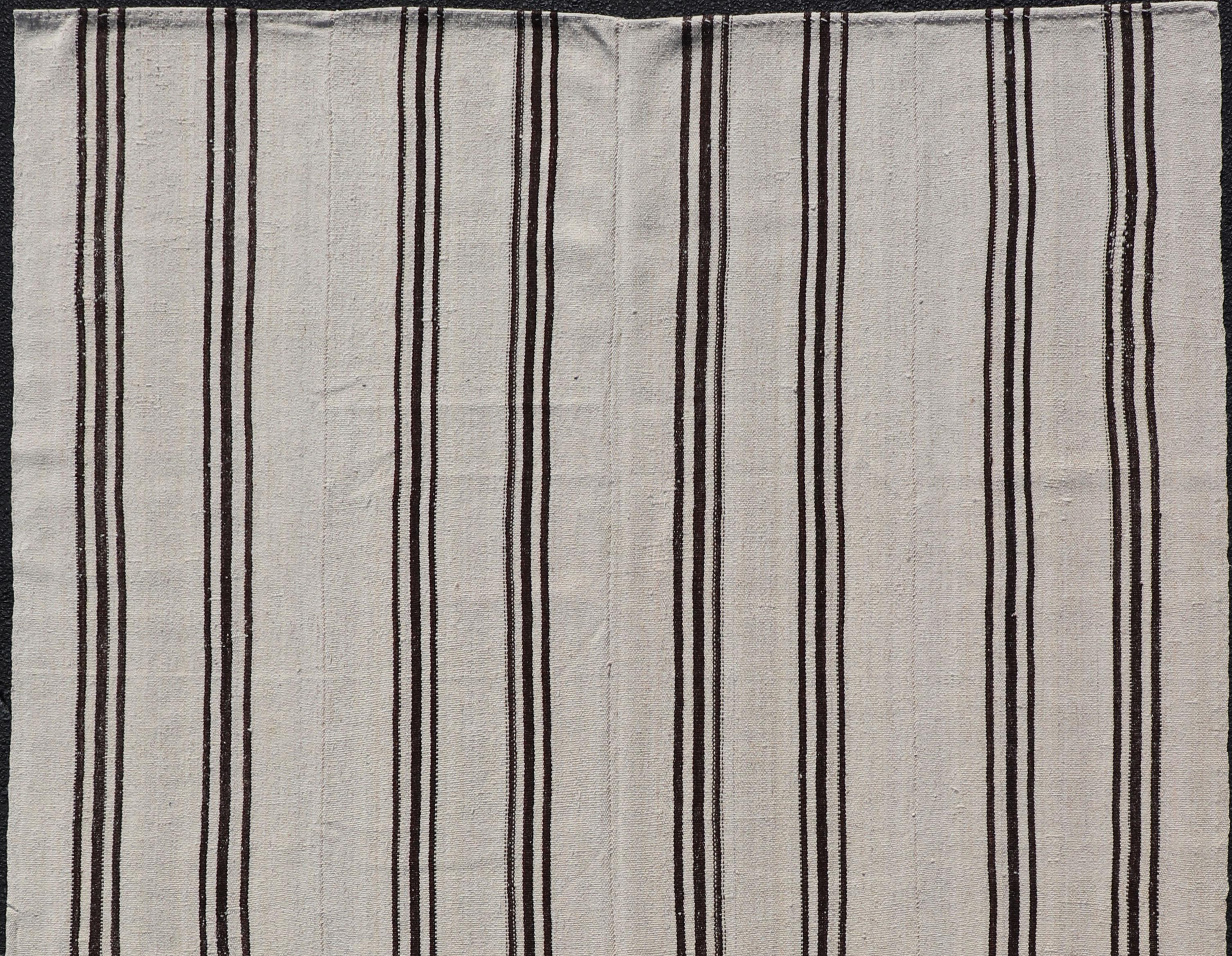 Flat-weave Kilim vintage rug from Turkey with vertical stripes in brown and cream. Keivan Woven Arts Rug TU-NED-1021-3, country of origin / type: Turkey / Kilim, circa 1950

Woven during the mid-20th century in Turkey, this Kilim is decorated with