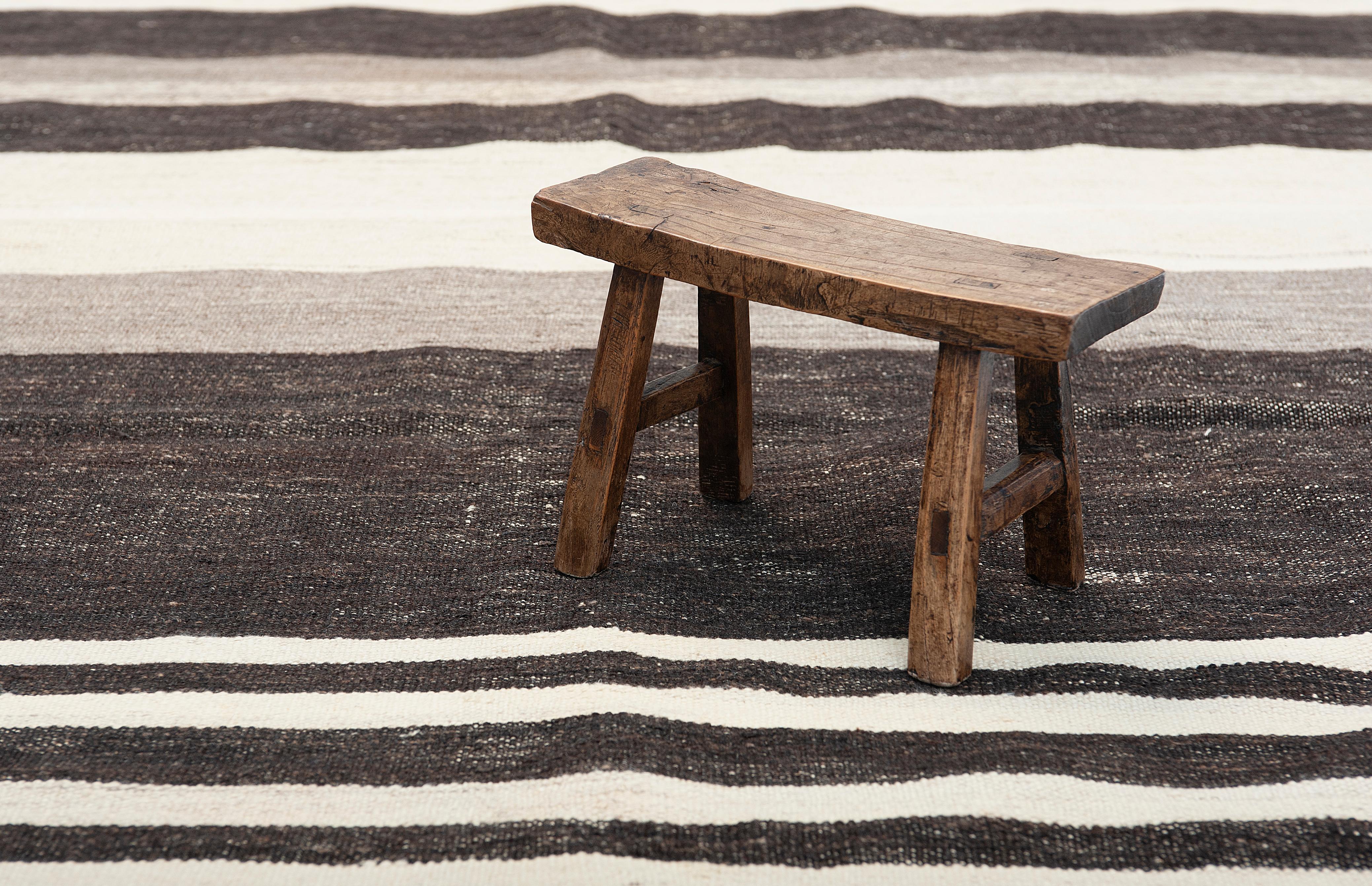 A vintage runner weaved in contrasting neutral tones, with seamless transitions of stripes that would transform any space with its warm and fresh appeal. This powerful statement piece captures all the essence, beauty and simplicity of a Kilim.