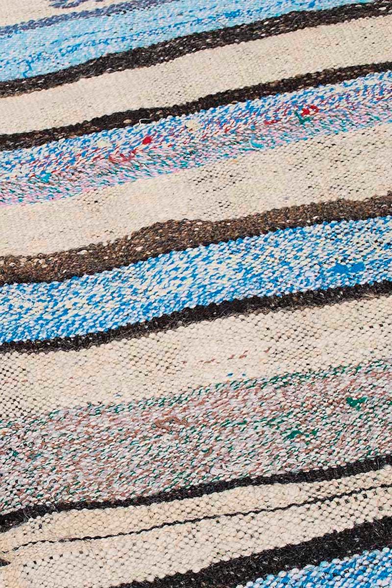 This beautiful Kilim was handwoven in the east part region of Turkey. 
The horizontal colorful lines in shades of sea green and light blue are extremely rare, making this a very special flat-weave.
It is remarkable that something so rich in color,