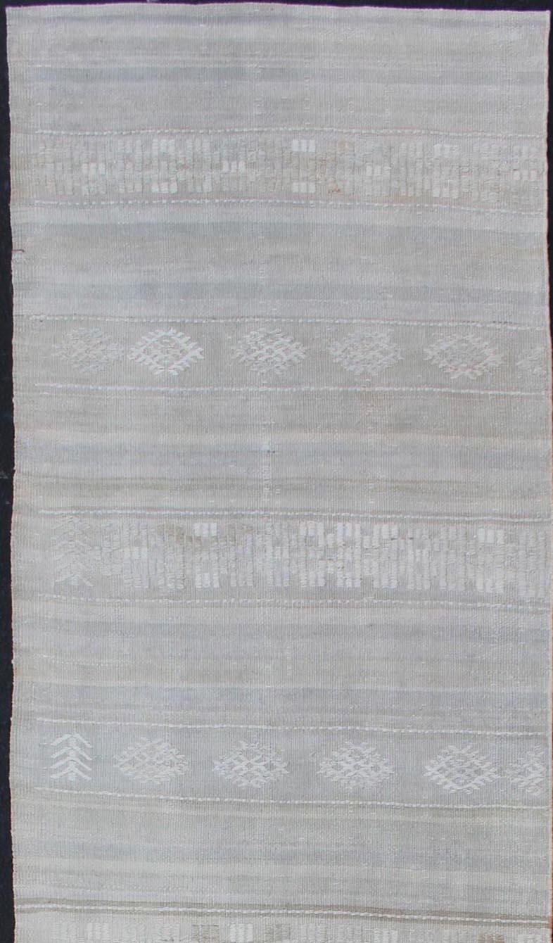 Stripe design Kilim runner in cream, light grey, light taupe and muted tones. Keivan Woven Arts / rug EN-176729-1, country of origin / type: Turkey / Kilim, circa 1950

This flat-woven Kilim runner from Turkey features an exciting composition