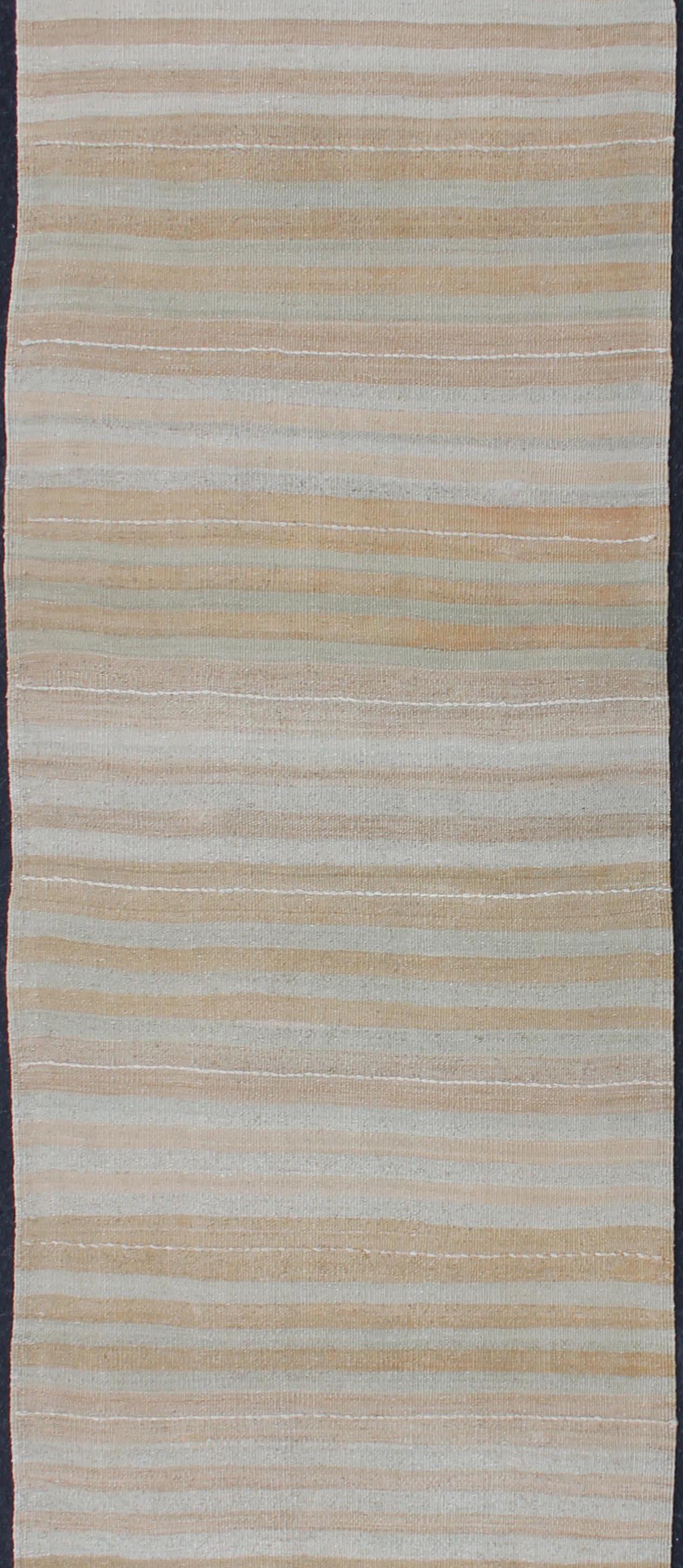 Stripe design Kilim runner in cream, light blue, light brown, light green, taupe, and butter yellow tones rug EN-179539, country of origin / type: Turkey / Kilim, circa 1950

This flat-woven Kilim runner from Turkey features an exciting