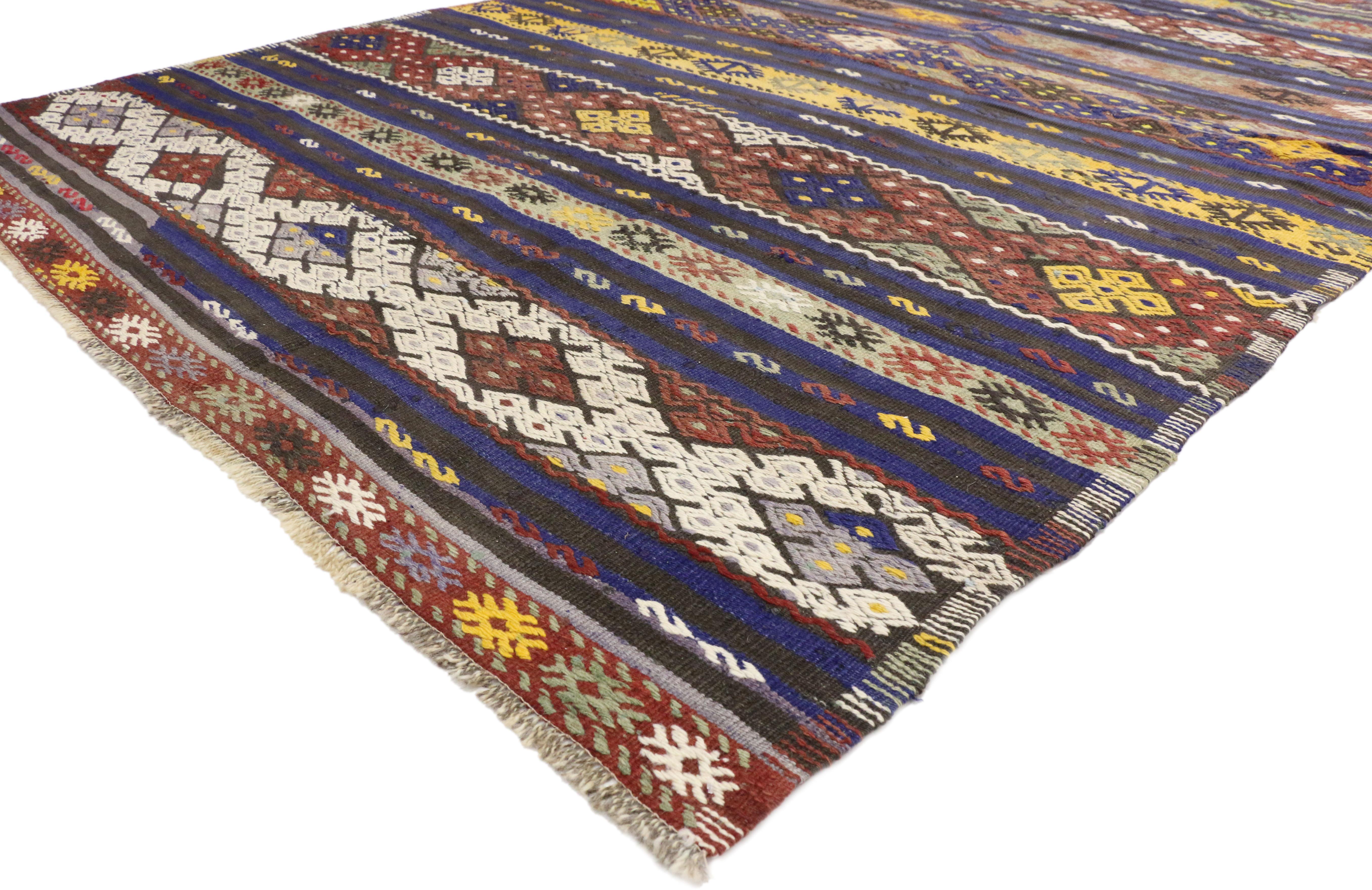 51337, vintage Turkish Kilim Striped rug with Bohemian Tribal style, flat-weave rug. This handwoven wool vintage Turkish Kilim rug features multi-color geometric tribal motifs and stripes. This Kilim rug is rich in Turkish culture, as the symbolic