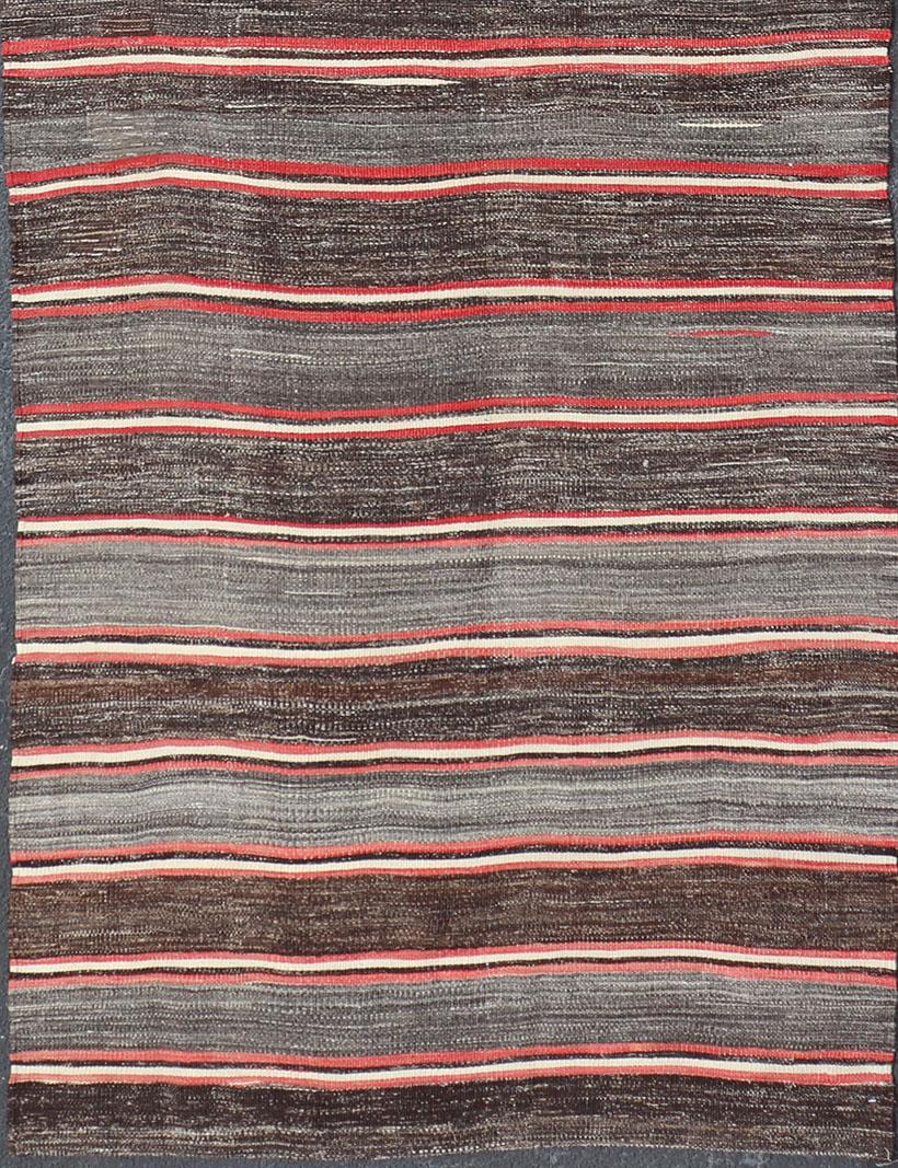 Turkish Kilim vintage runner with stripes in brown, gray, coral, charcoal, rug EN-1184, country of origin / type: Turkey / Kilim, circa mid-20th century

Woven during the mid-20th century in Turkey, this designer Kilim is decorated with a