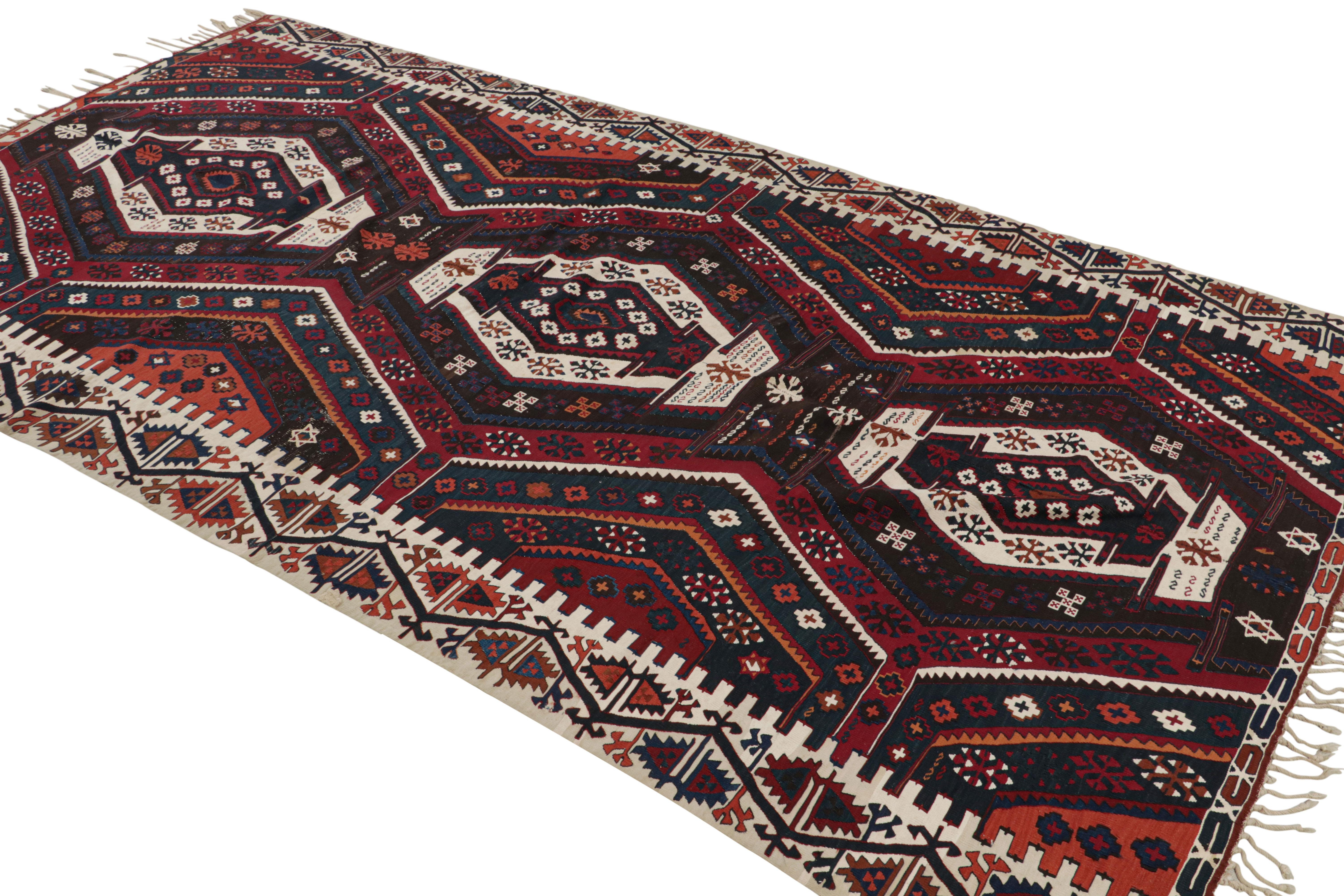 Hand woven in wool, this vintage 6x12 Turkish kilim features all-over polychromatic geometric patterns on a rich burgundy red field. 

On the Design: 

Connoisseurs will admire this personal vintage piece meant to catch the eye, yet still so