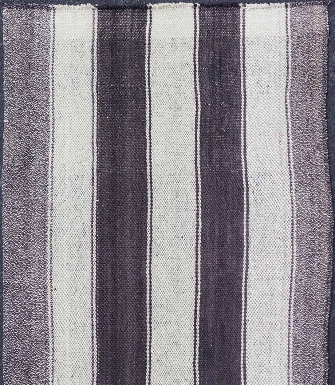 Measures: 2'7 x 6'2 

This vintage flat weave Kilim has a very modern stripe design. Rendered in ebony, cream. With neutral colors and simple design, this flat weave is perfect for any modern and transitional interior. 

Country of Origin: Turkey;