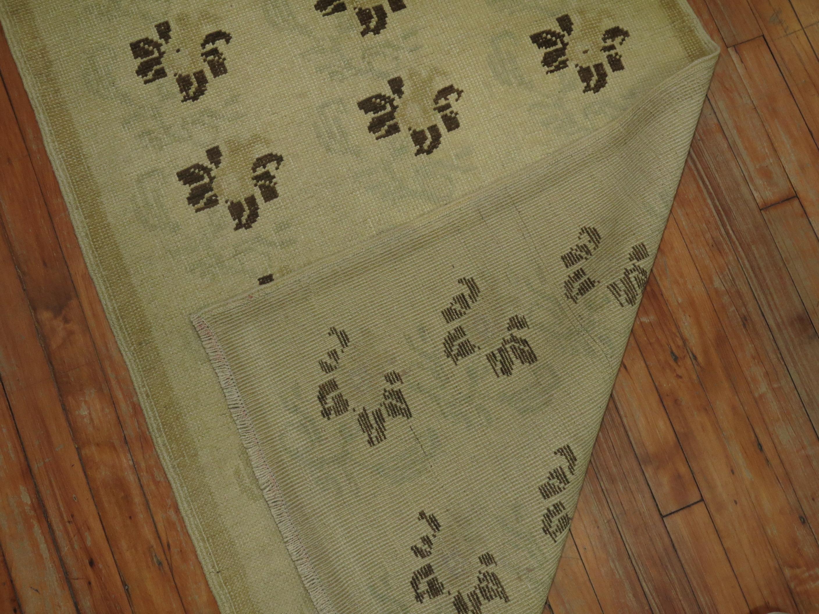 Short vintage Turkish Konya runner. Accents in beige, brown and green accents.