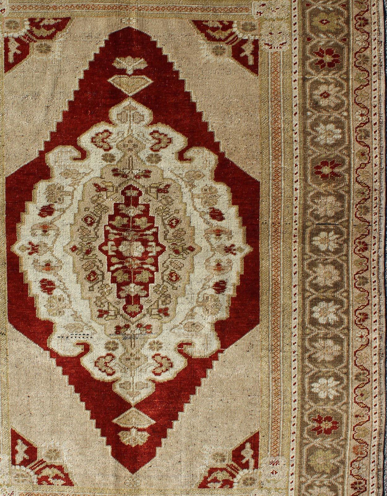 Measures: 4'10 x 7'4

This vintage, midcentury Turkish Oushak rug features an intricately beautiful design with a traditional aesthetic. The central medallion is surrounded by multi-layers in the central field. The various shades of tan, taupe,