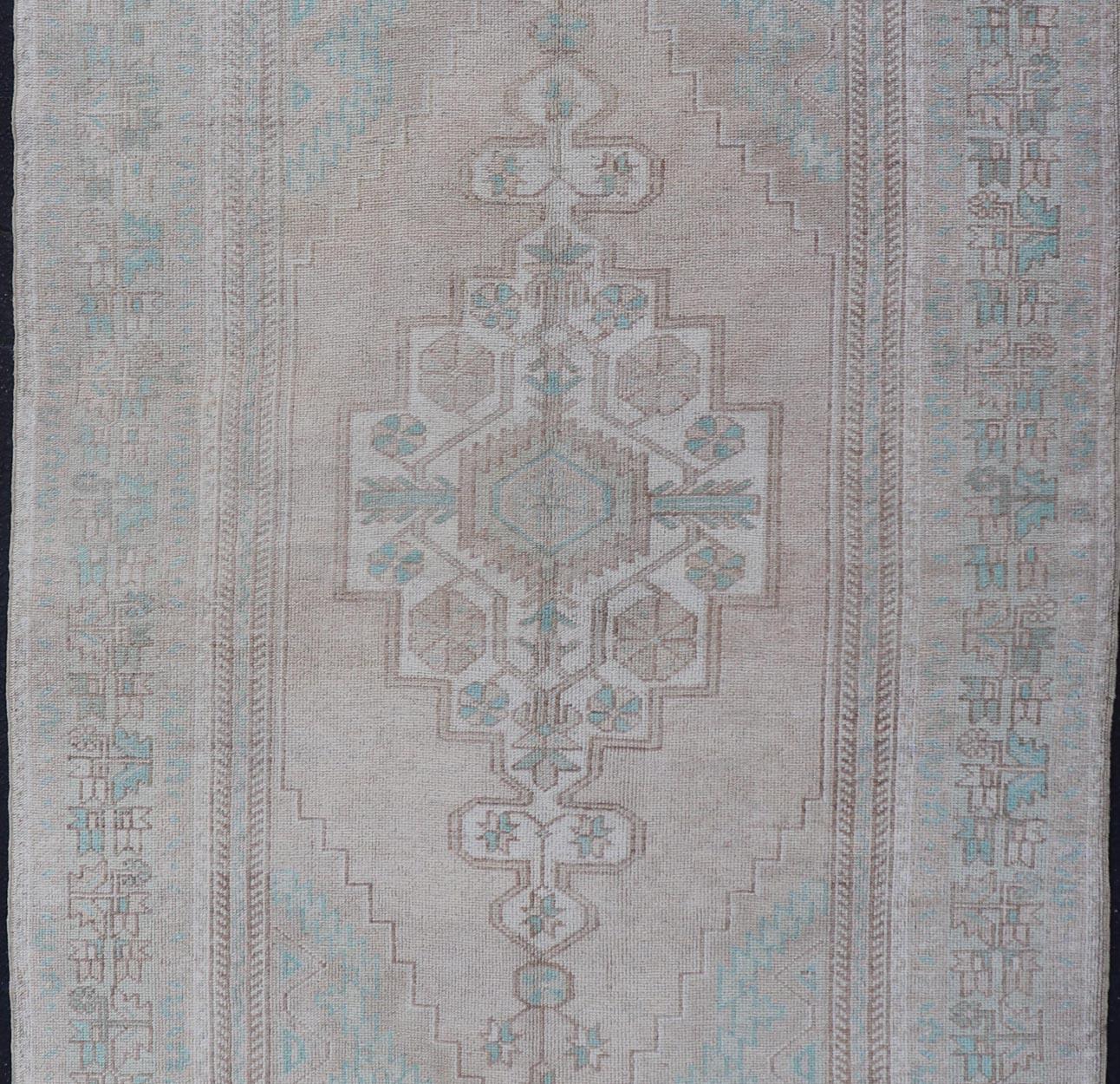 Measures: 4'7 x 8'4 

This vintage beauty was hand-knotted in Turkey during the 1950's. Vintage Oushak rugs are incredibly popular for their durability, as well as their ability to compliment many different interiors due to the wide range of