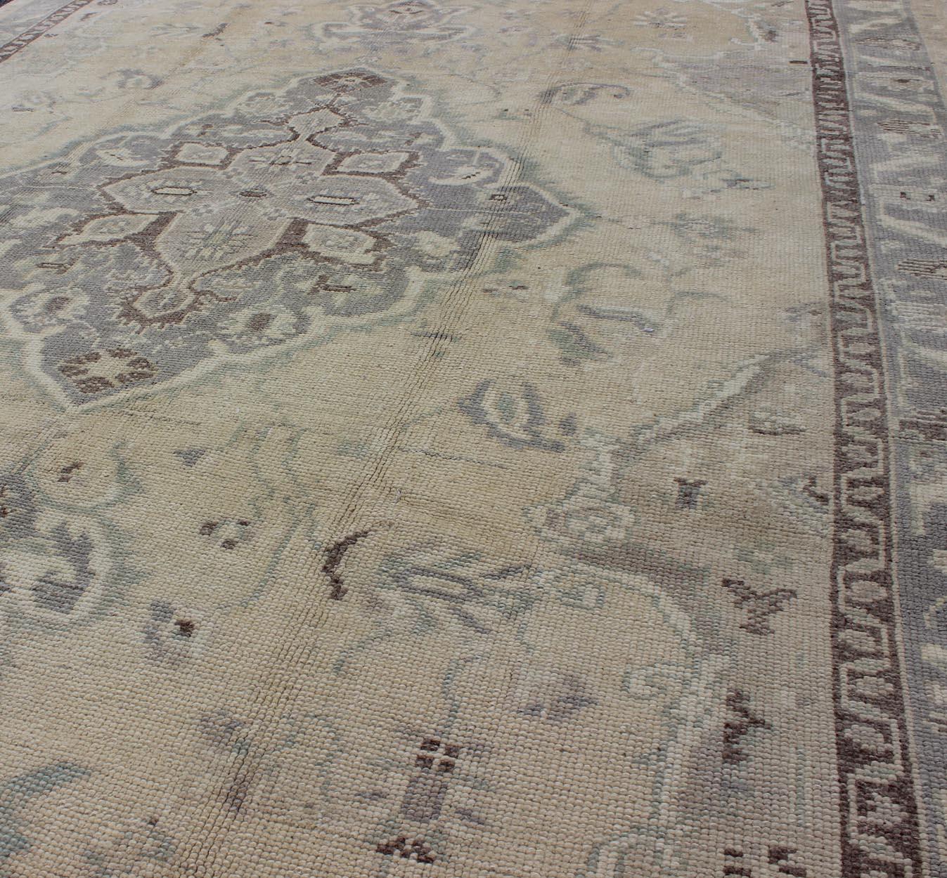 Vintage Turkish Medallion Oushak in Muted yellow, blue, light green, peach & lilac; country of origin: Turkey; type: oushak; design: Medallion, floral medallion, all-over, floral; Keivan Woven Arts; rug /TU-DUR-3415

Measures: 6'1 x 9'9

This