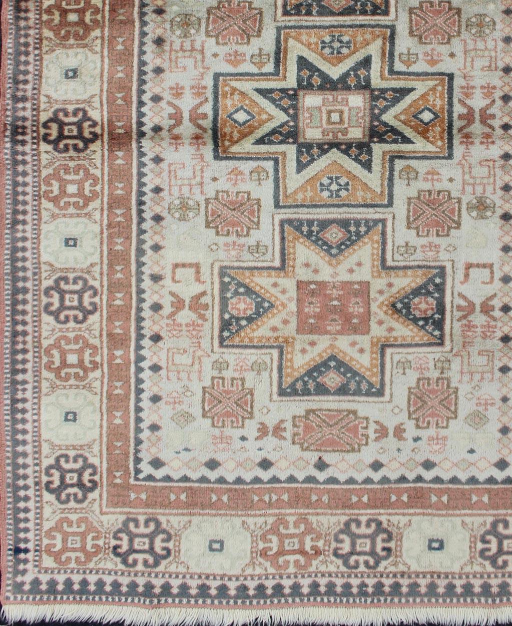 Vintage Hand Knotted Turkish Rug with Tribal Medallions and Design, Keivan Woven Arts /  rug 16-0302, country of origin / type: Turkey / Oushak, circa 1960

This Tribal rug from Turkey features a tri-medallion design rendered in cross shapes and a