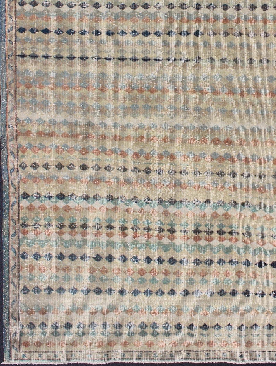 Mid century Modern Turkish vintage rug with taupe background and colorful stripe design, rug en-141420, country of origin / type: Turkey / Oushak, circa 1950.

This modern-design vintage Turkish distressed rug features a modern design rendered in